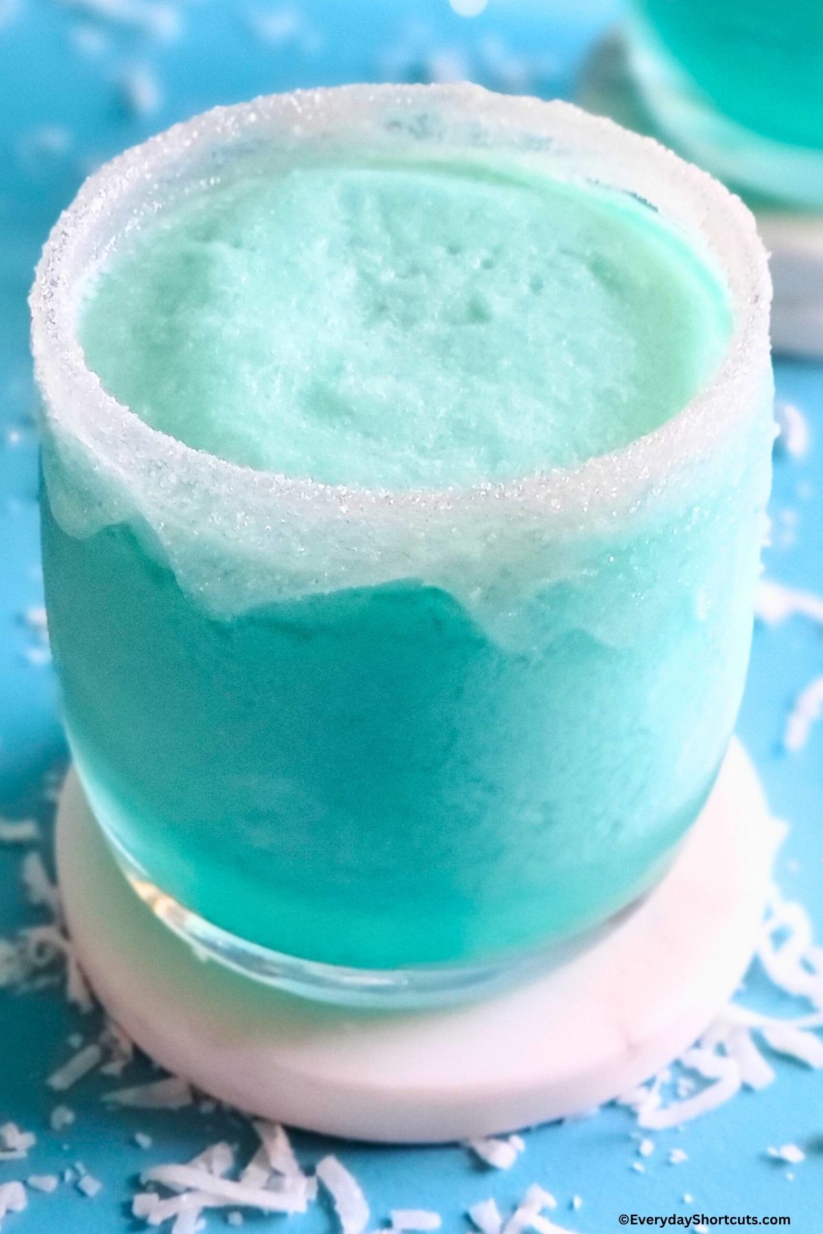frozen blue pina colada with sanding sugar in a glass