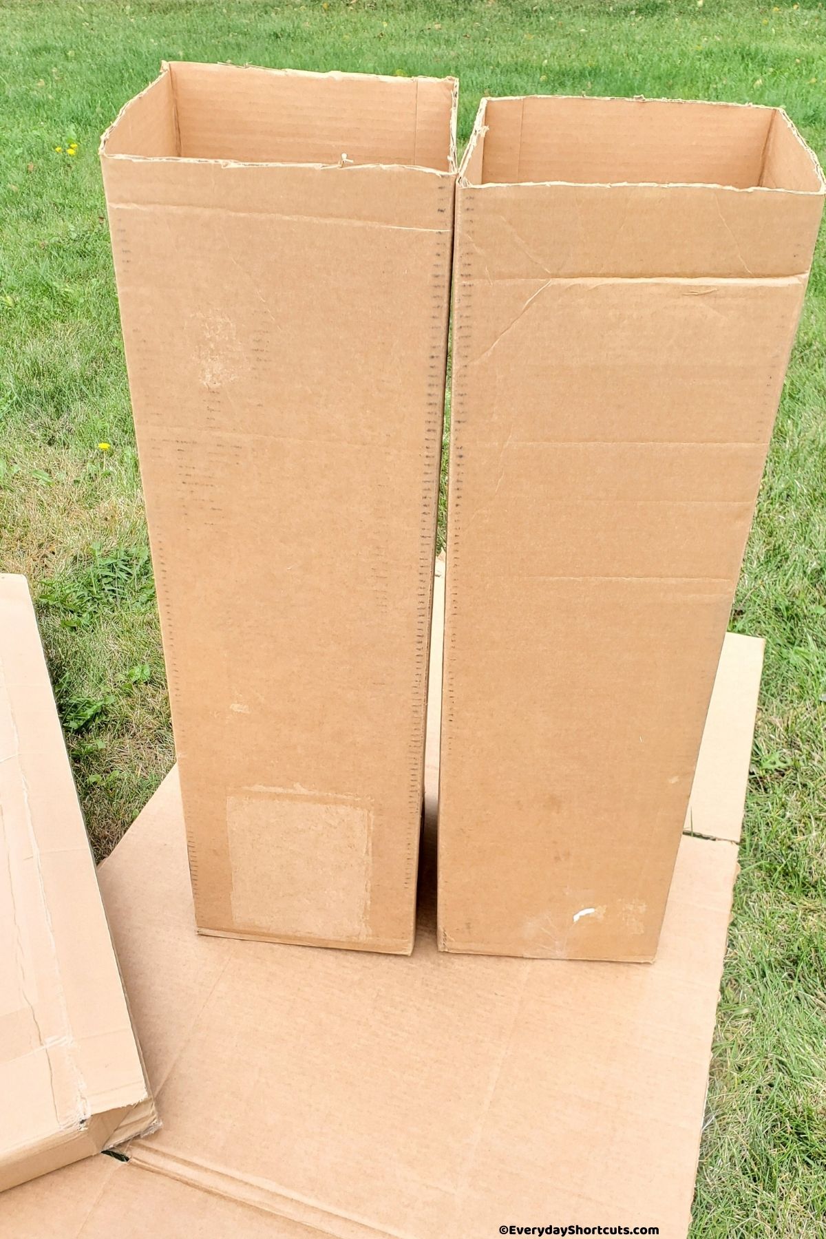 tall cardboard boxes cut into two for cemetery pillars