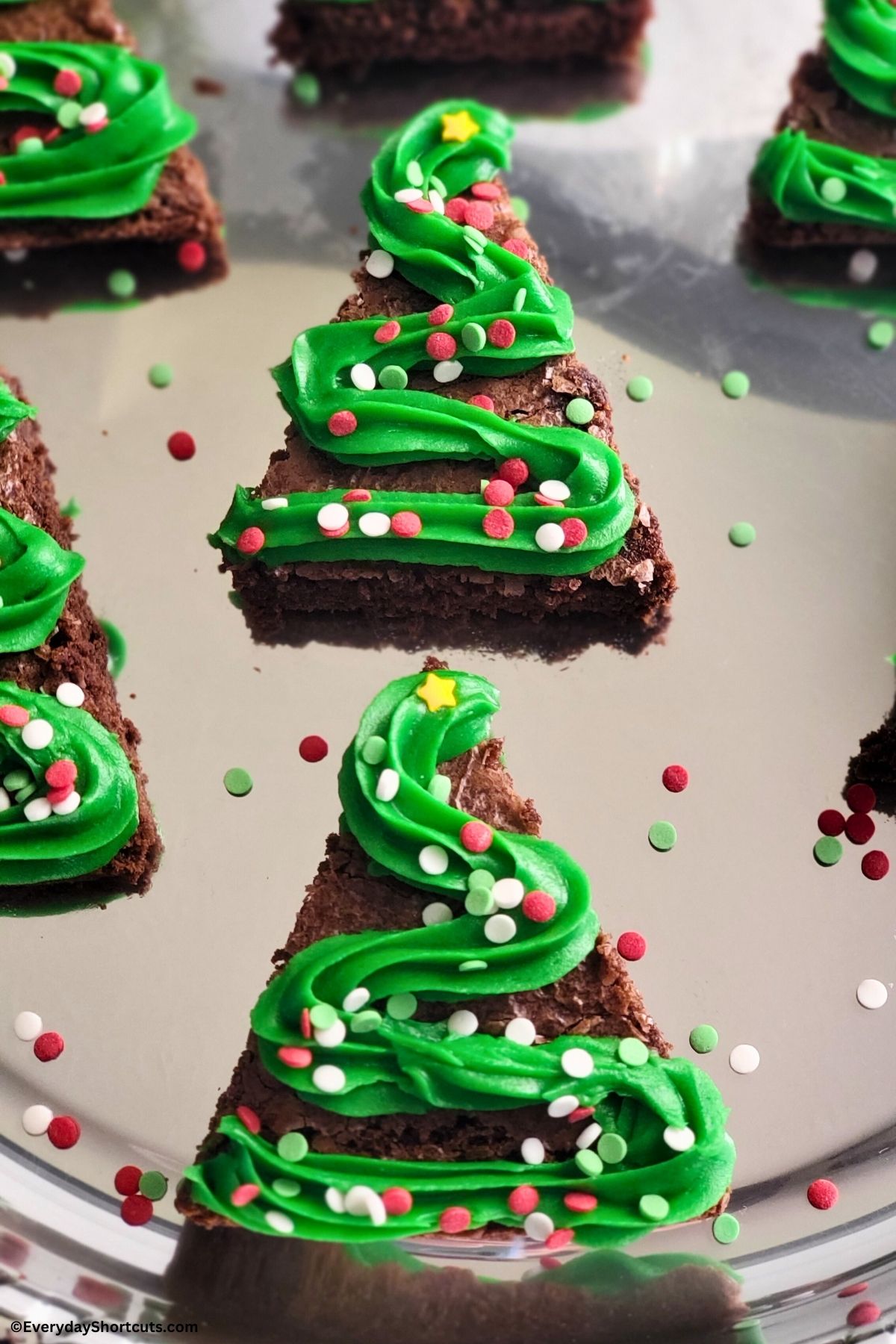 tree shaped brownies with frosting and sprinkles