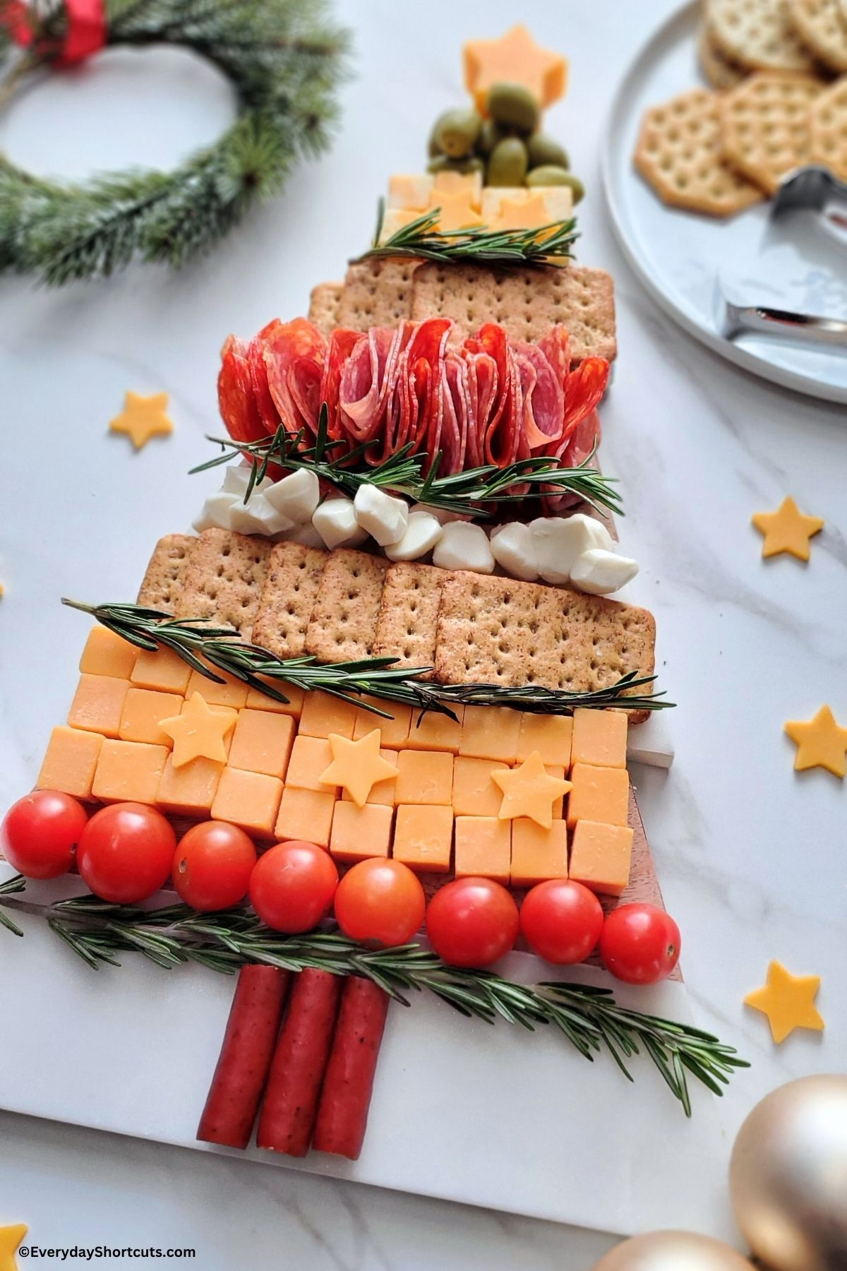 Christmas tree themed charcuterie board with meats and cheeses