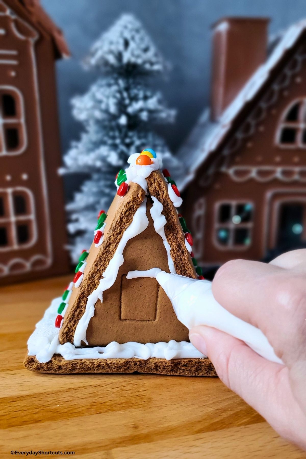 decorating a gingerbread house with royal icing