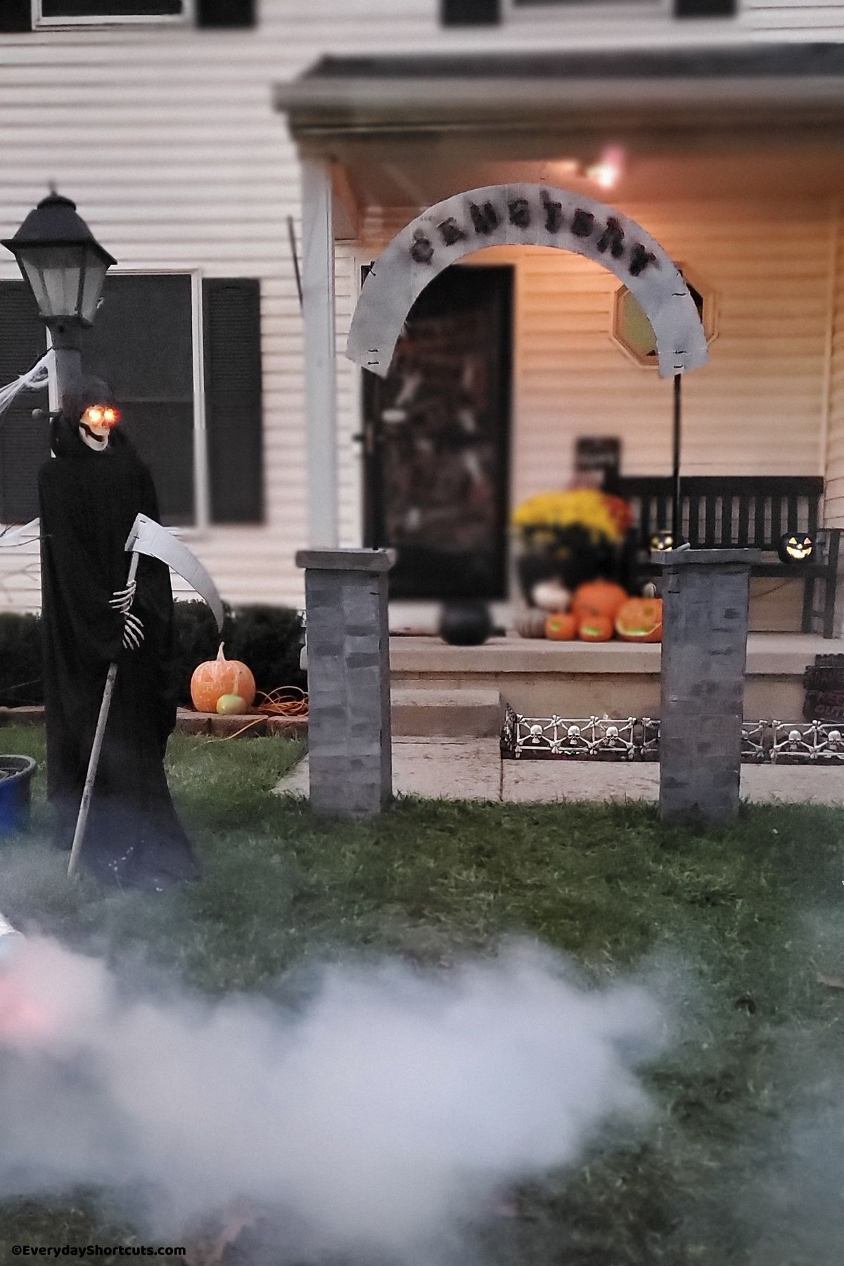 diy grim reaper with glowing eyes in haunted yard cemetery