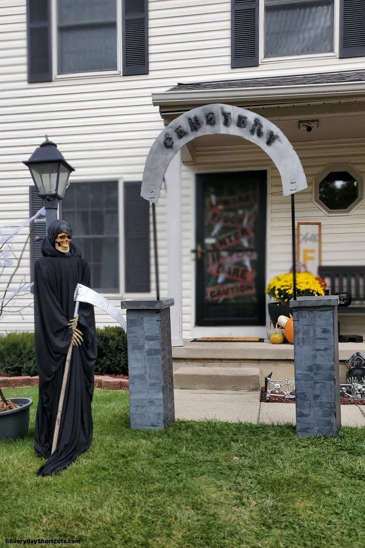 cemetery sign and pillars with grim reaper