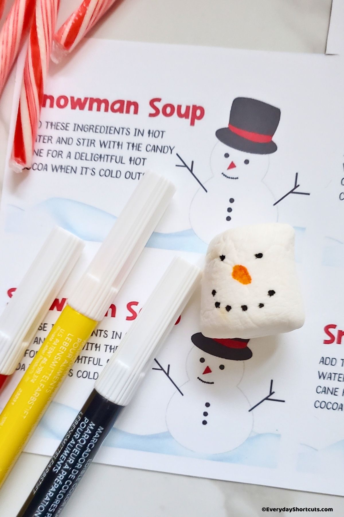painted snowman face on a marshmallow with food markers