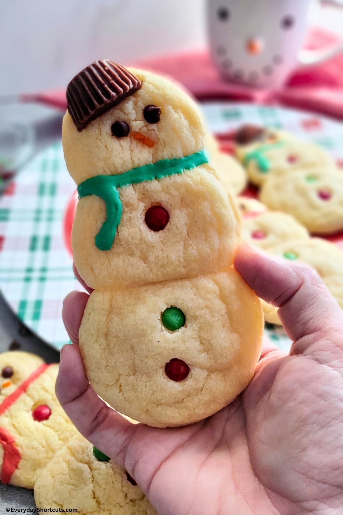 holding a snowman sugar cookie