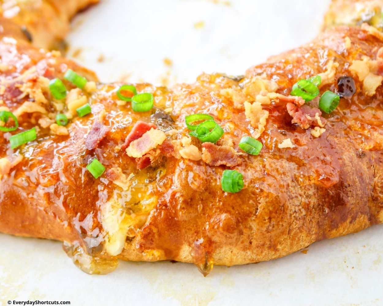 boudin cake garnished with sliced green onions and bacon