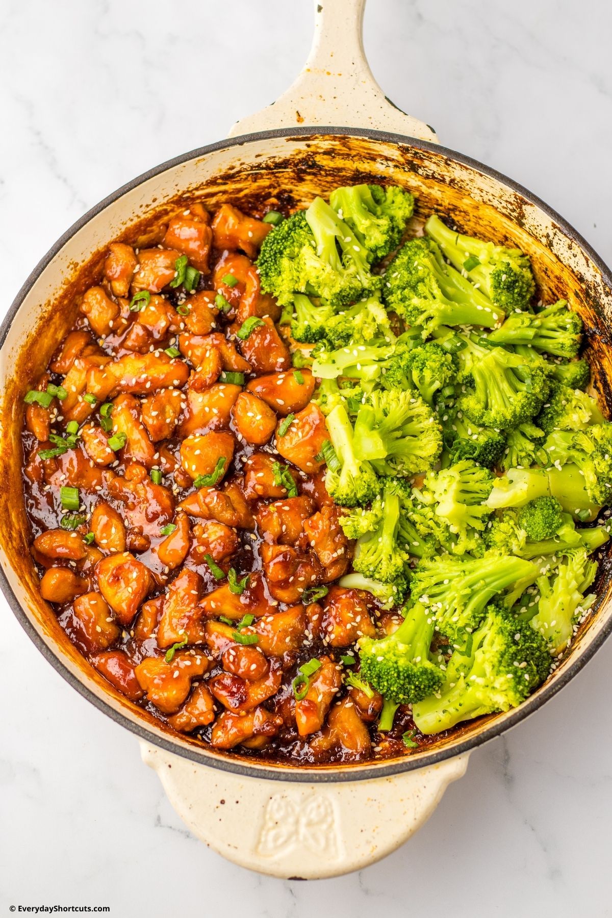 sesame seeds over top of sticky chicken and broccoli