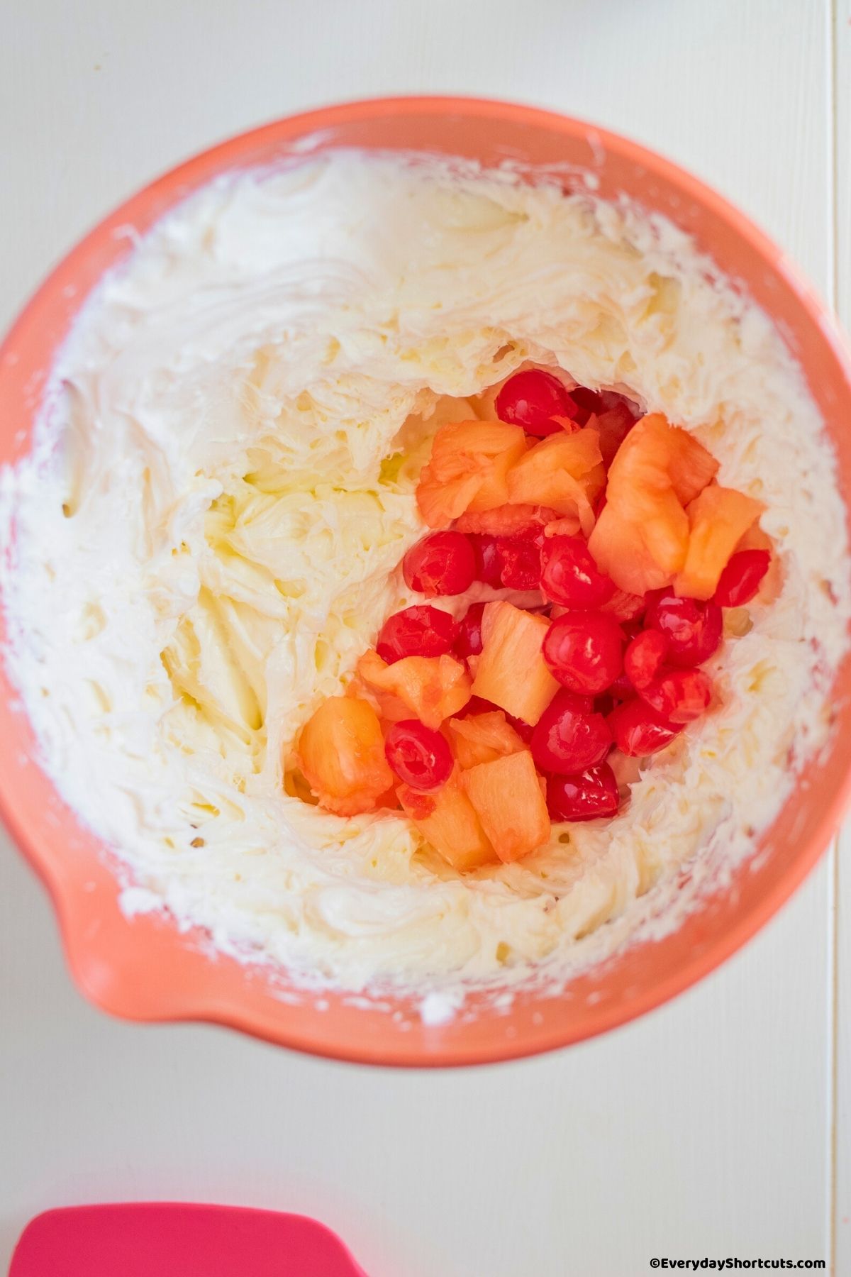 maraschino cherries mandarin oranges and pineapple chunks in cream cheese mixture