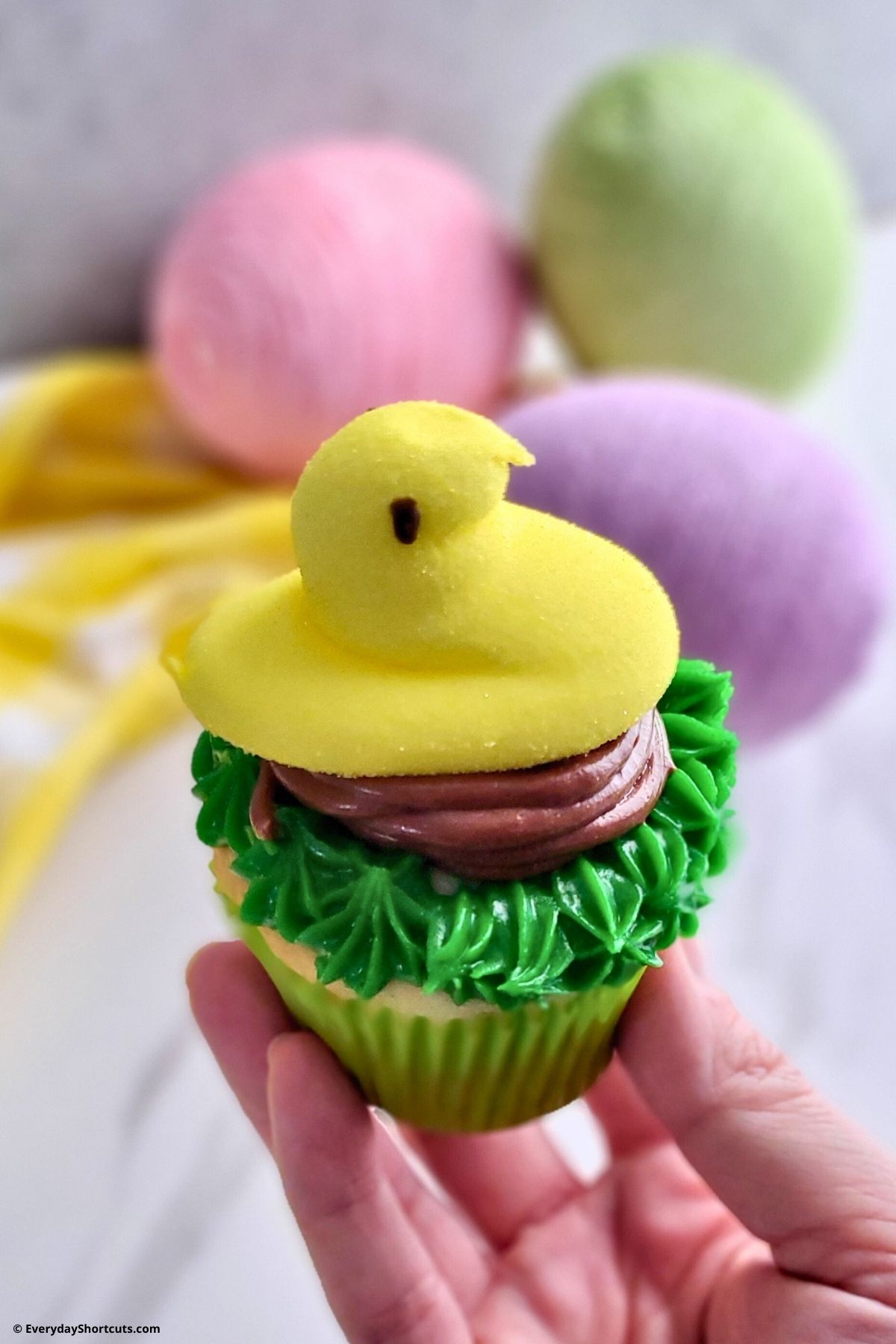 yellow chick peeps on top of cupcakes