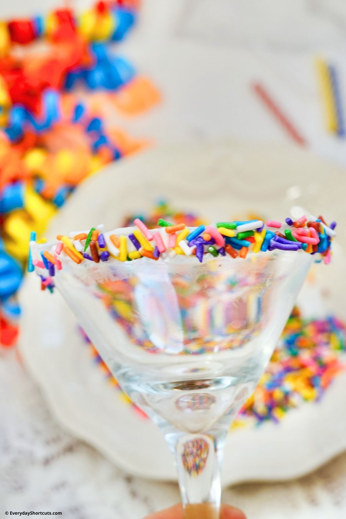 frosting and sprinkles on a martini glass