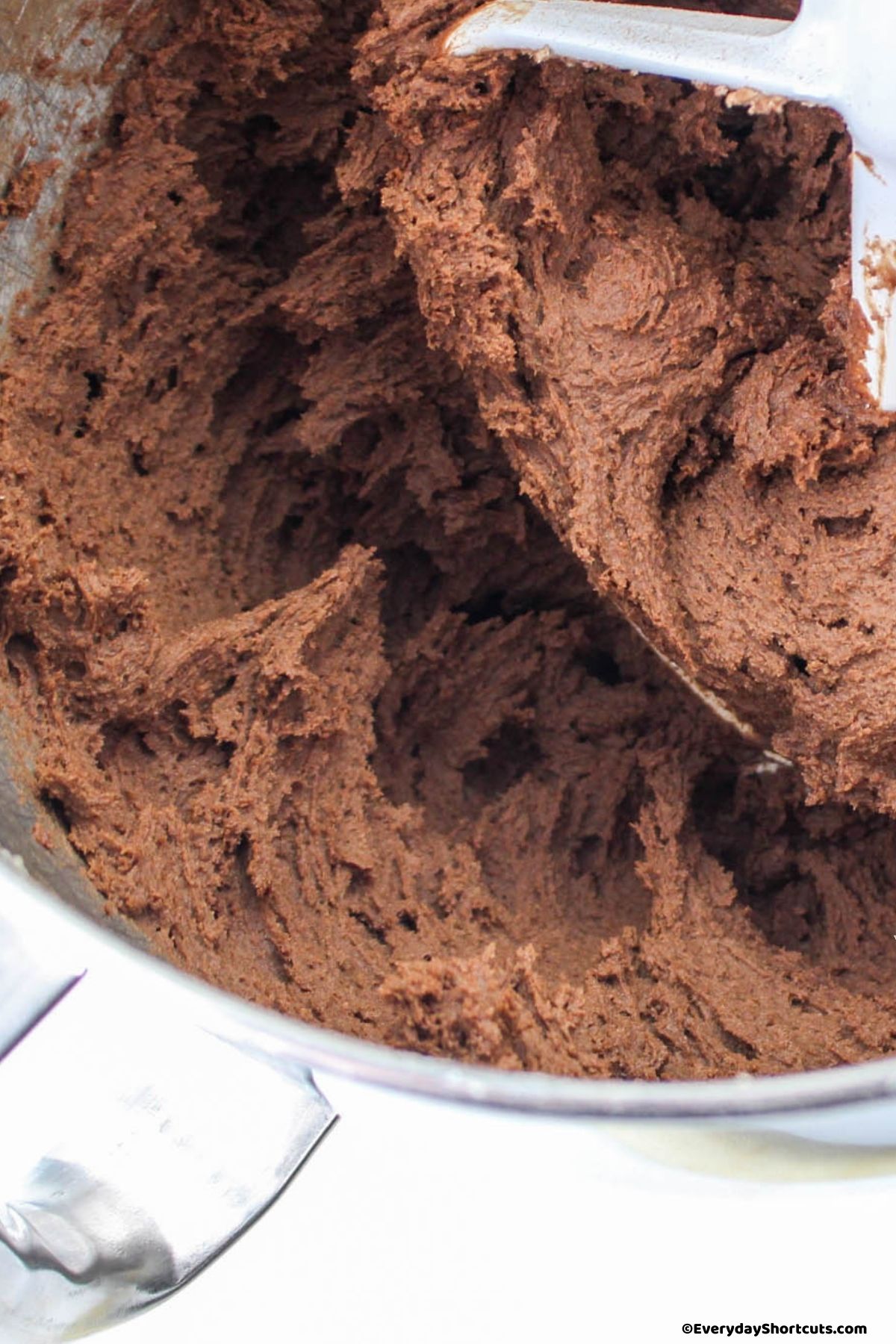 cocoa powder mixture mixed with butter mixture in a bowl