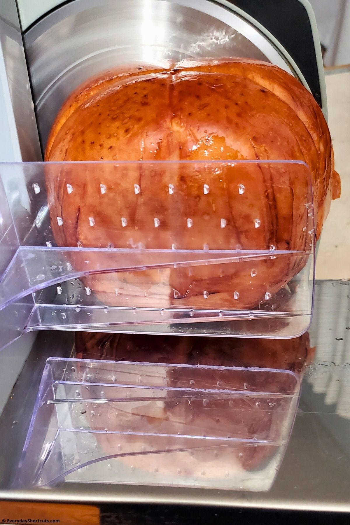 slab of ham on meat slicer