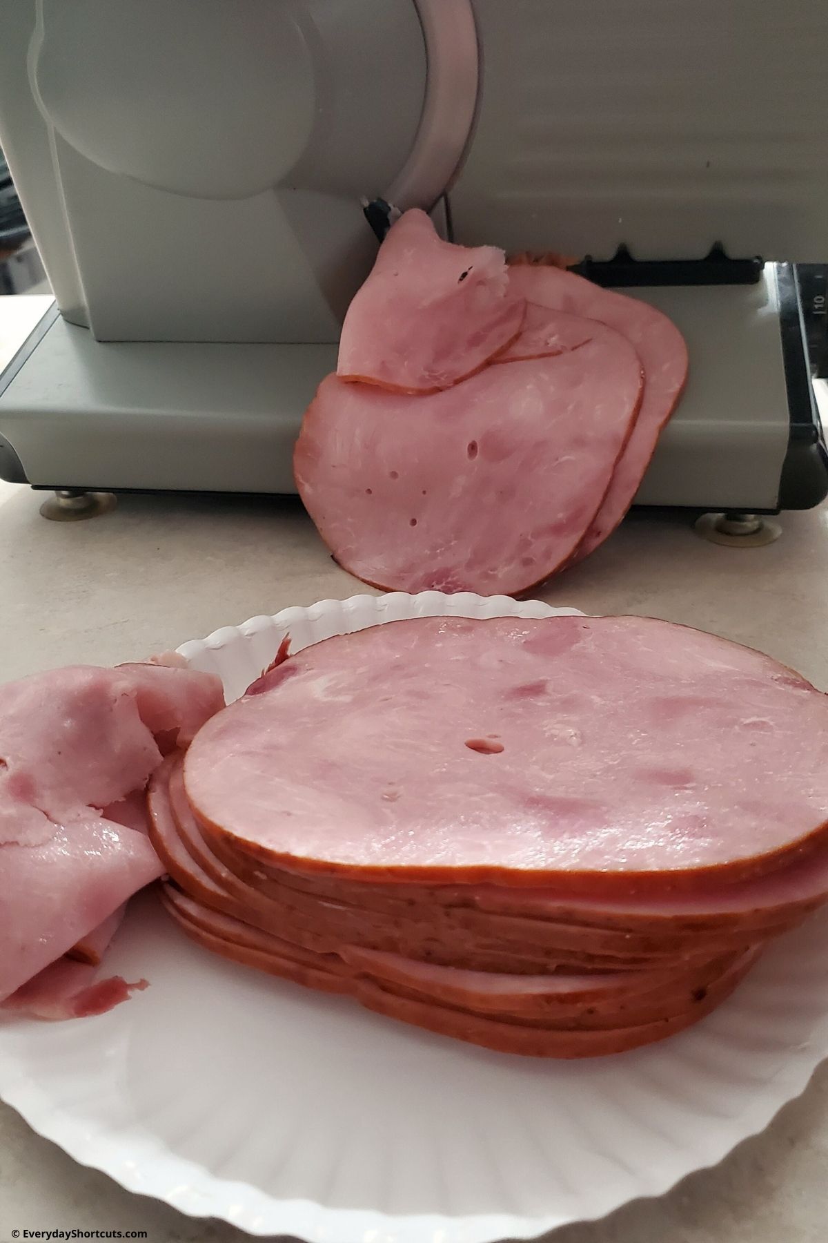 individual slices of ham from meat slicer
