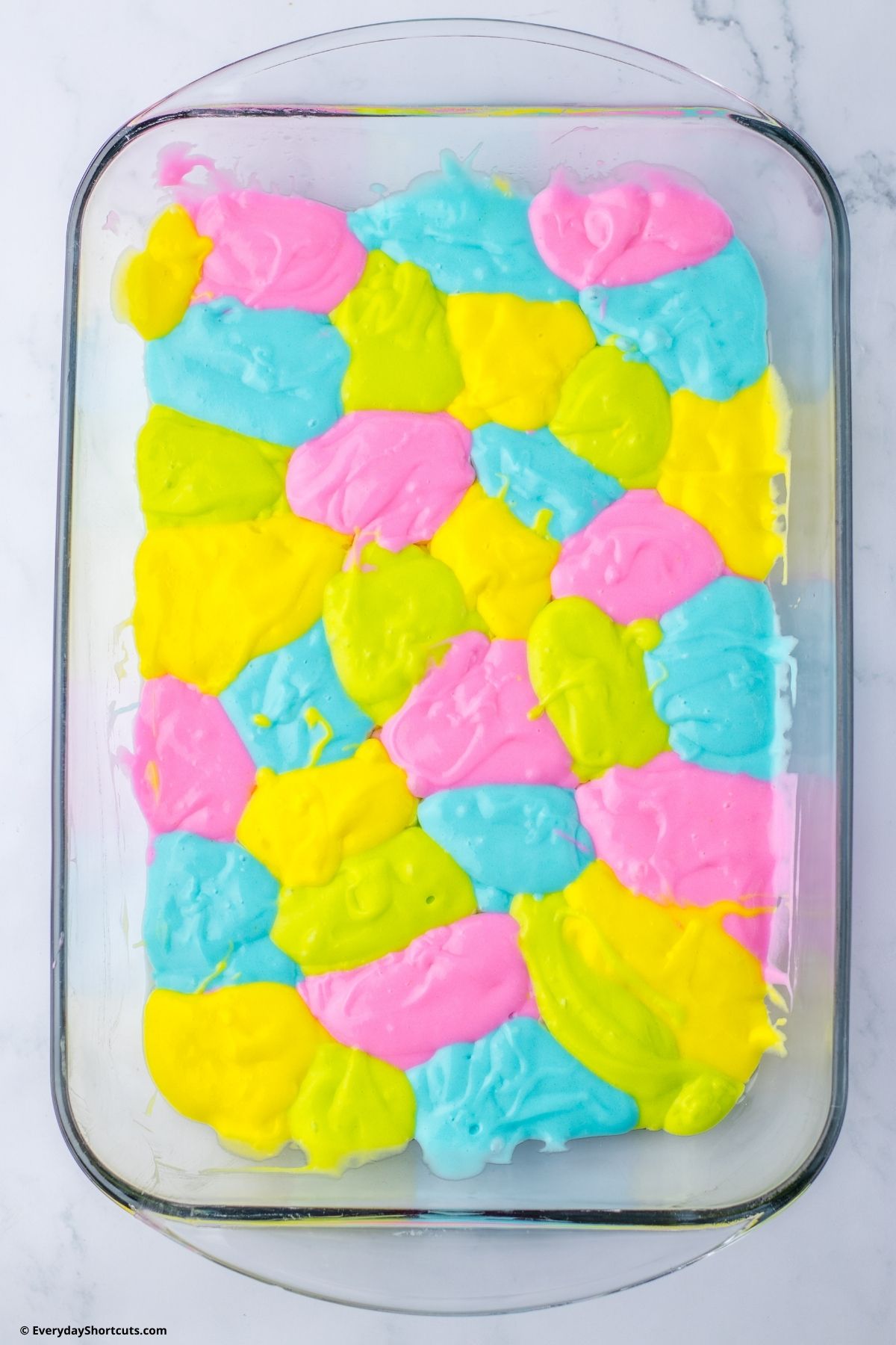 pastel colored cake batter in a baking dish