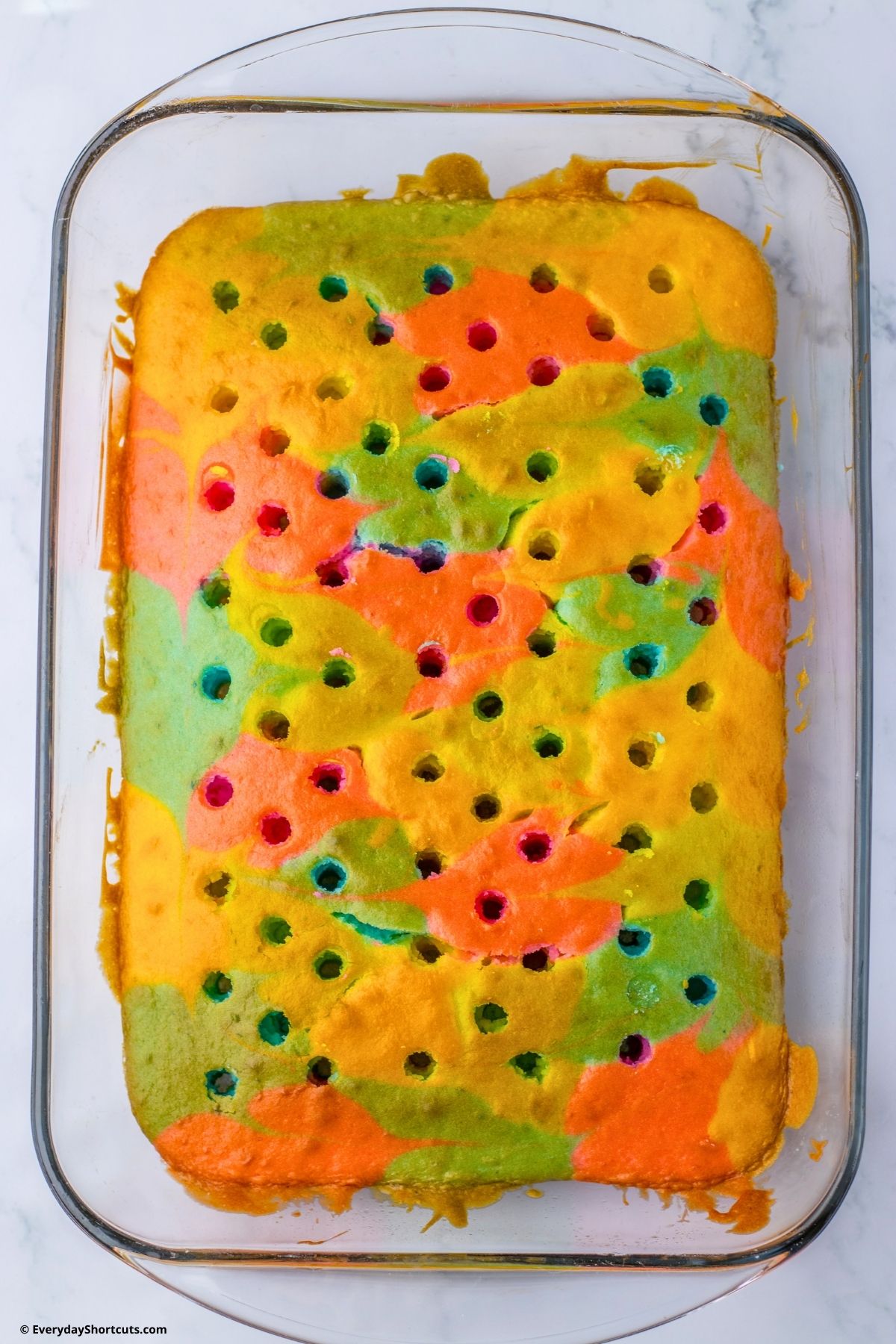 holes poked in cake batter