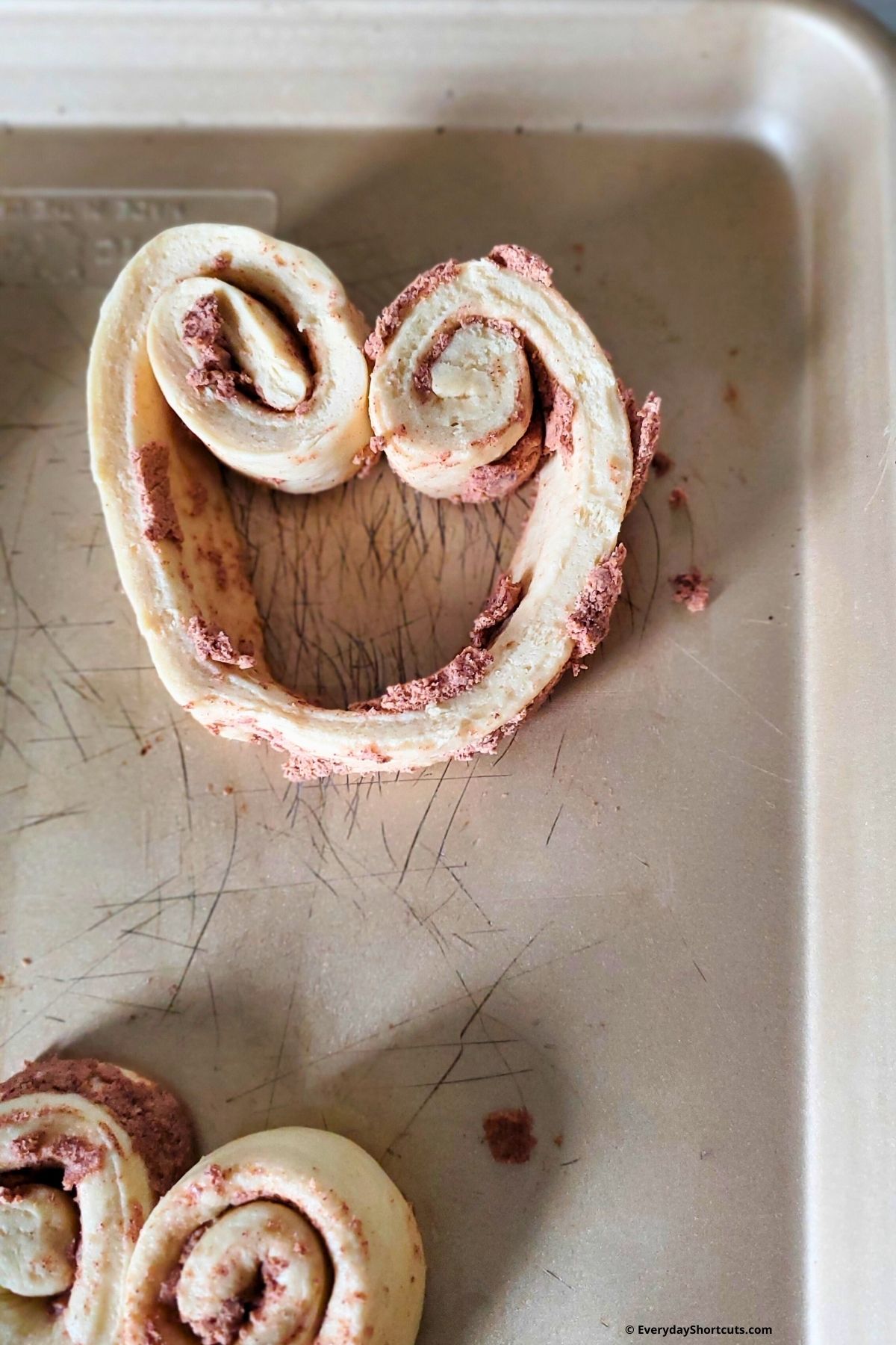 shaping a cinnamon roll into a heart