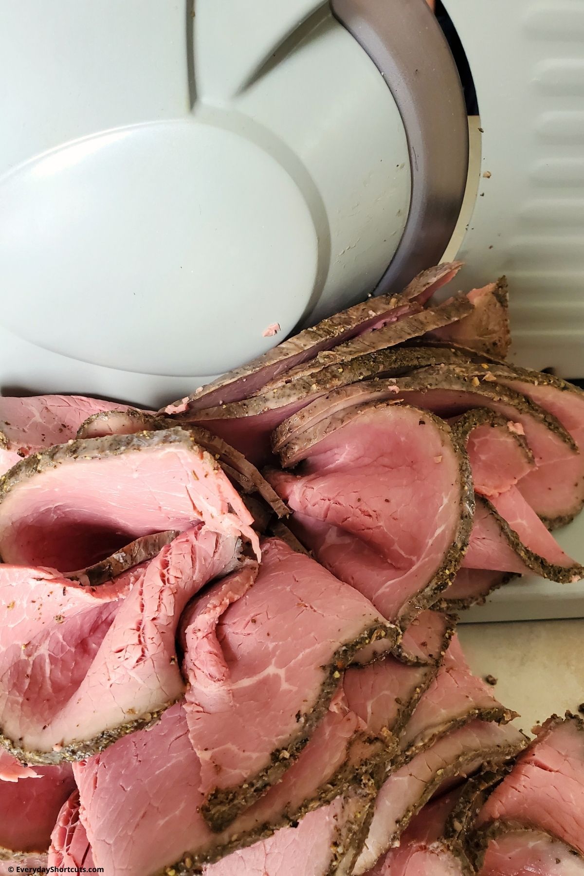 slicing roast beef on meat slicer