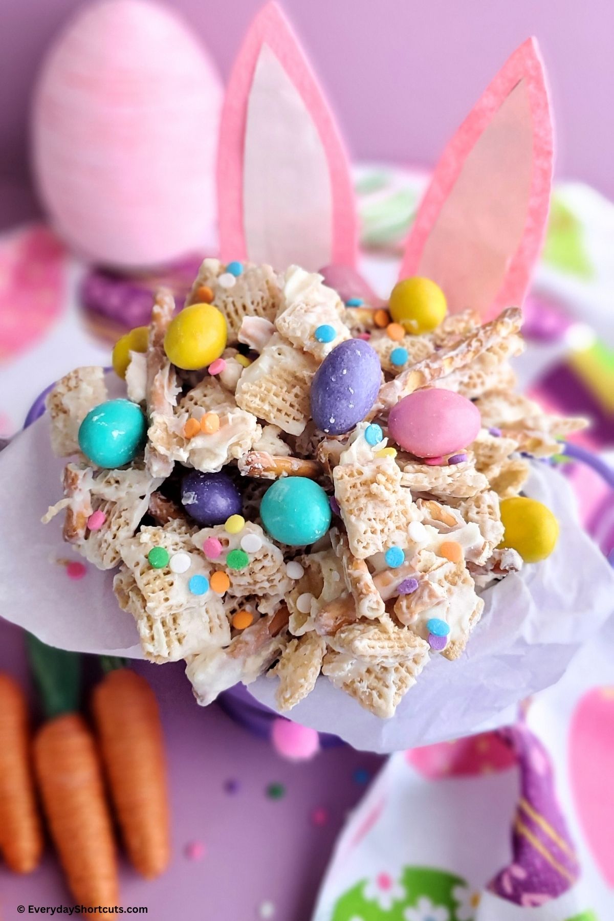 chocolate covered pretzels cereal and candy in a bunny bucket