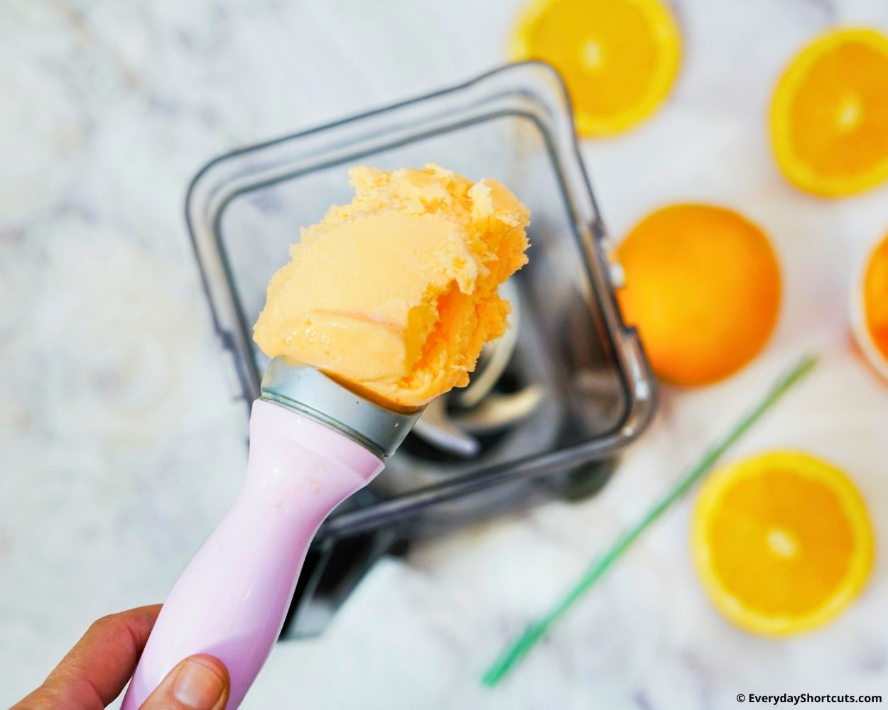 orange ice cream in a blender