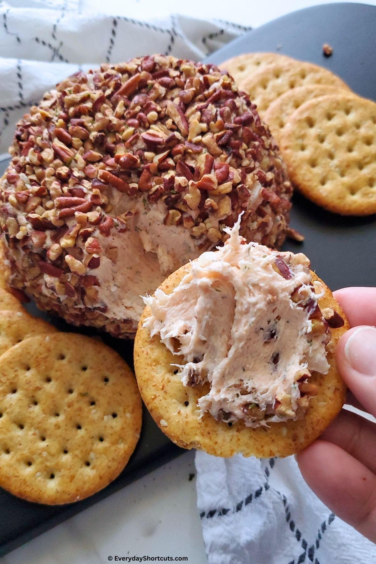 scoop of cheese ball on a cracker