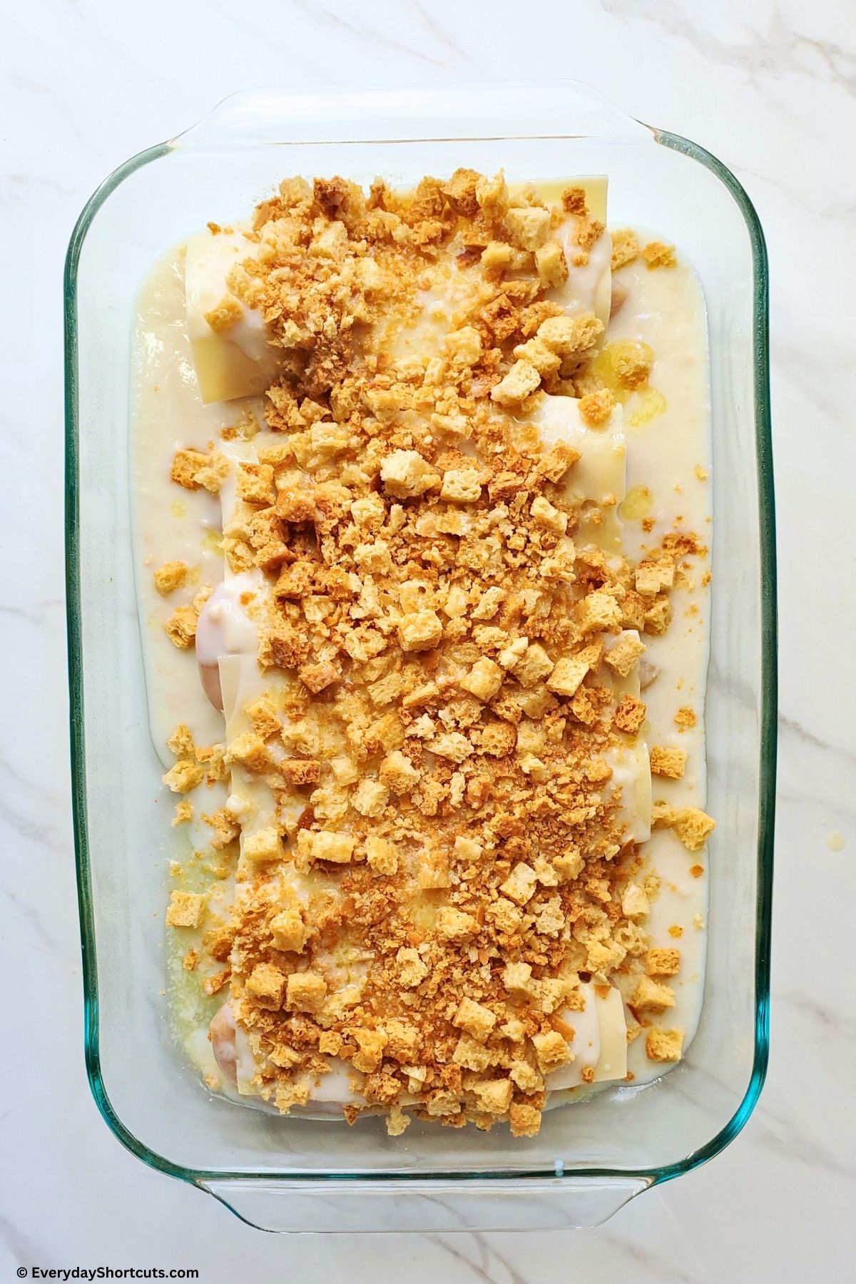 stuffing and melted butter on top of chicken and cheese