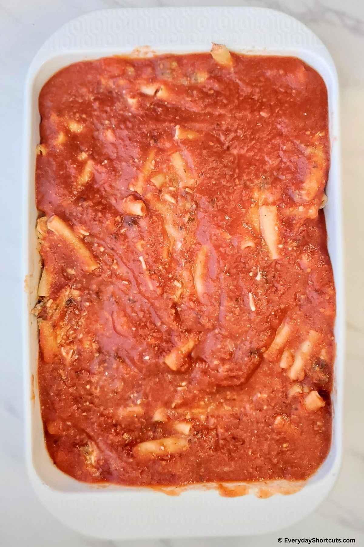 ziti ingredients spread in a baking dish