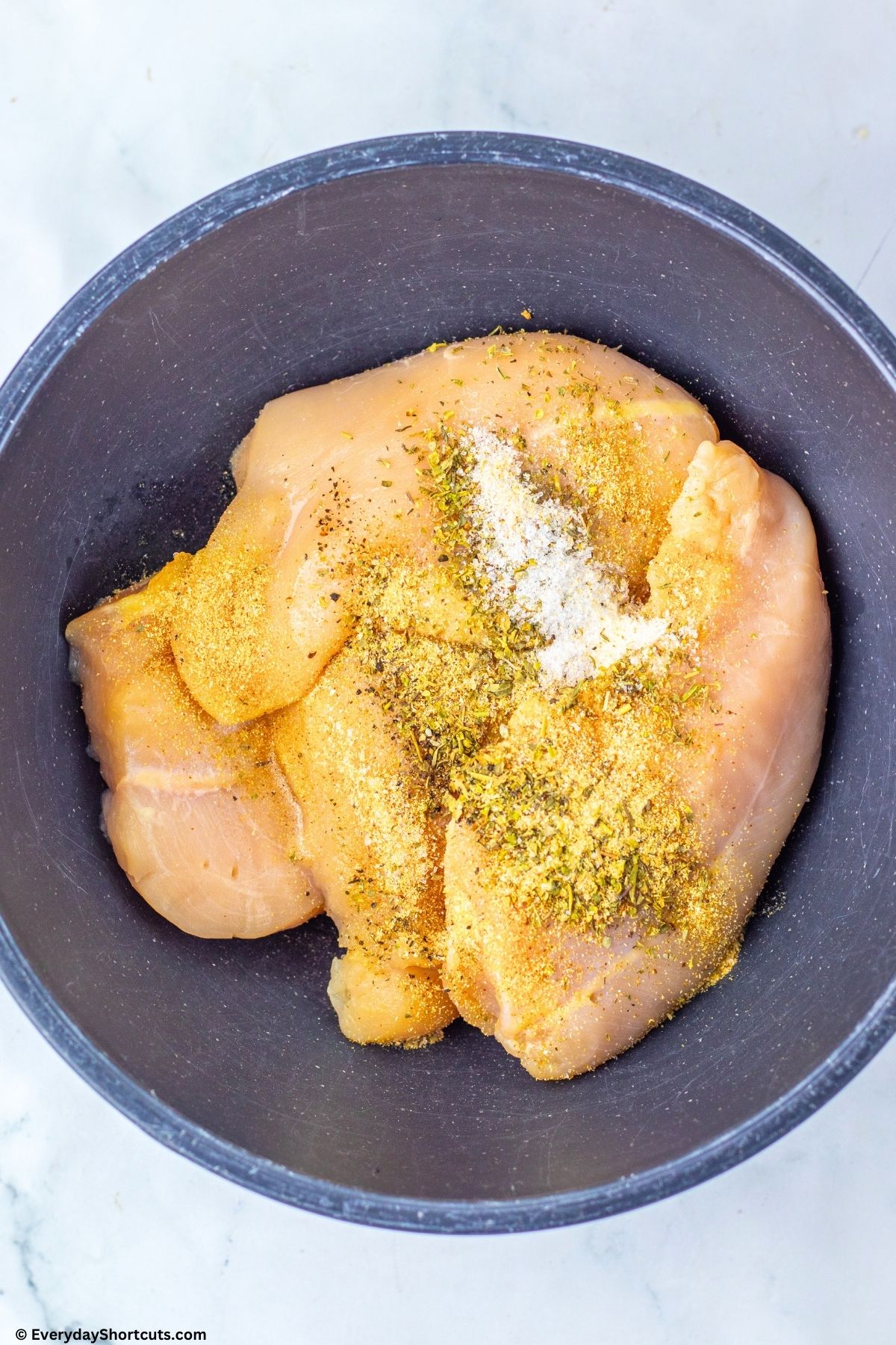 chicken and seasonings in bowl