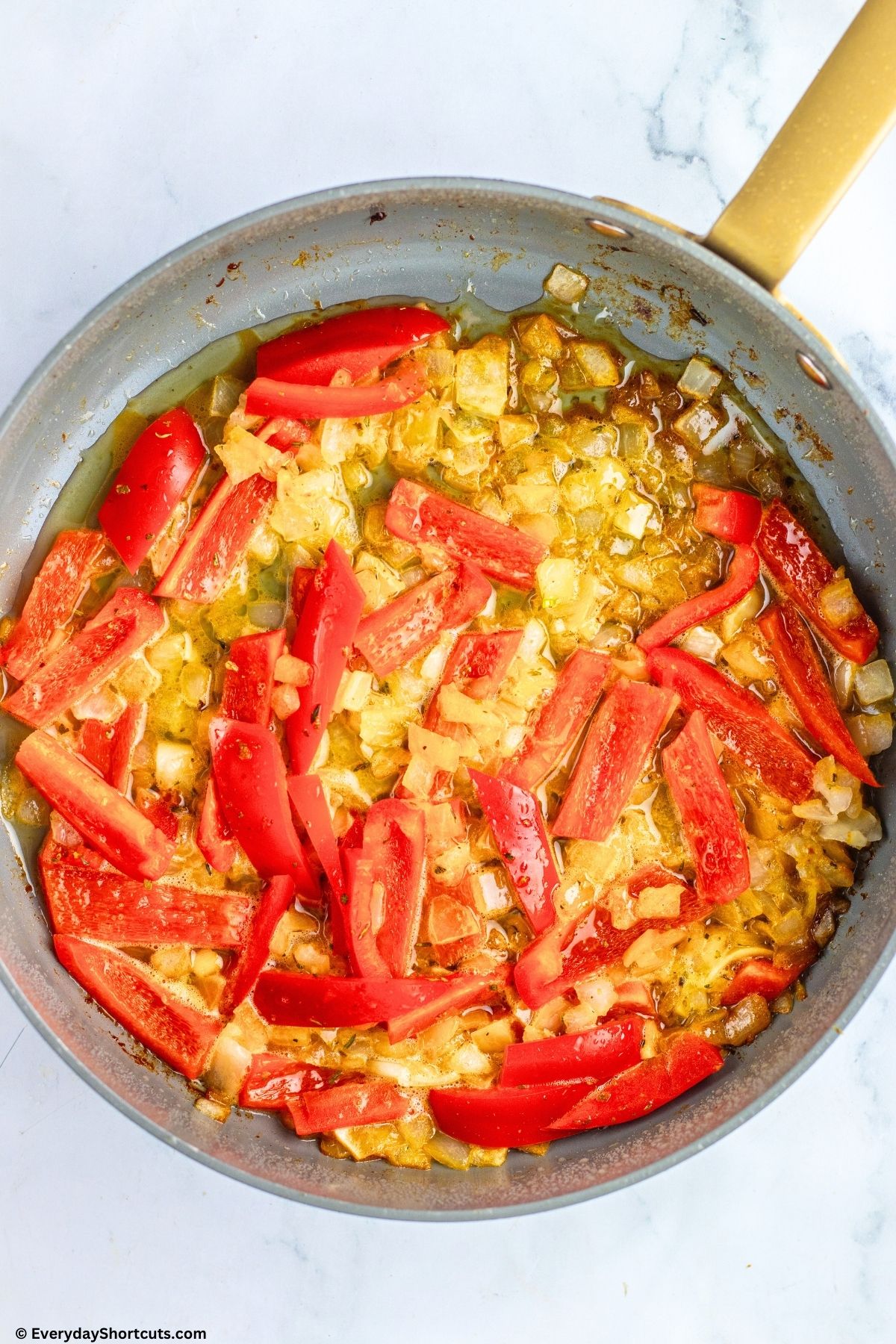 bell peppers and onions sauted in pan