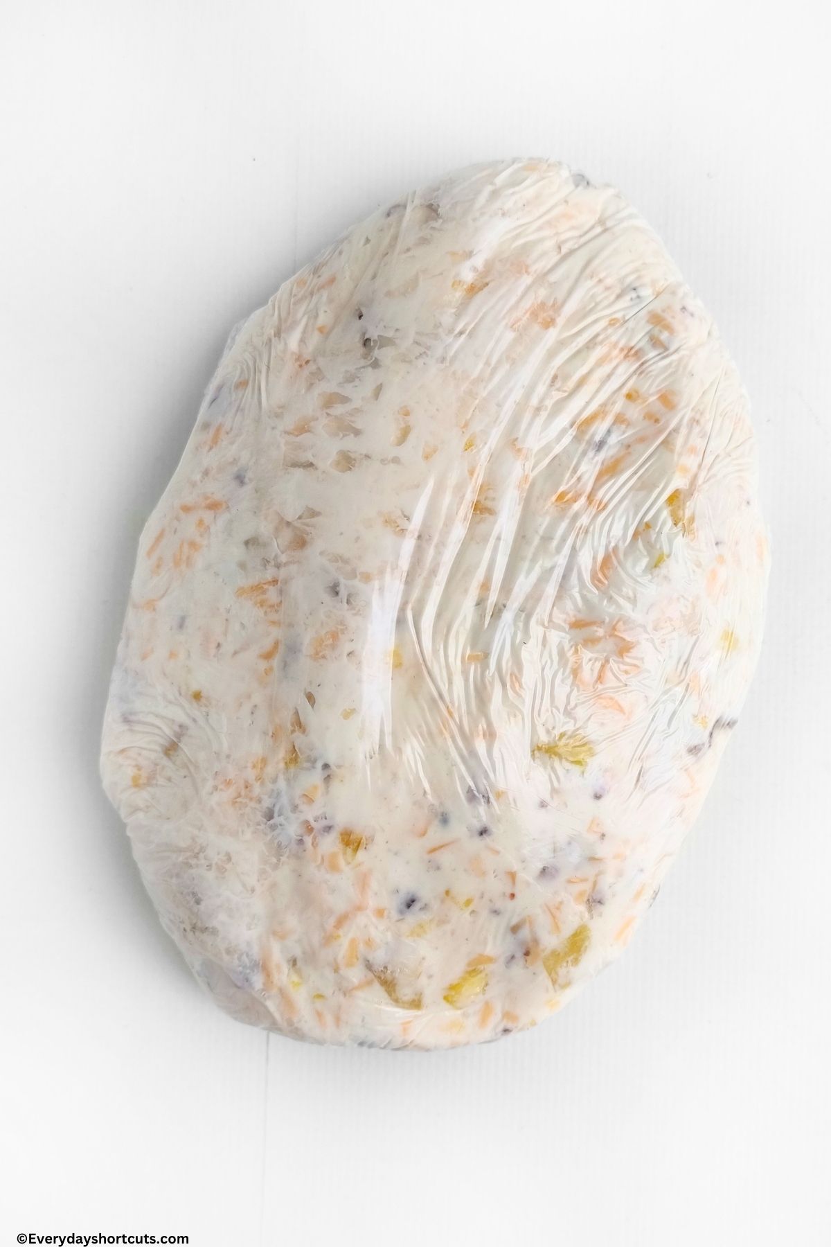Hawaiian cheese ball wrapped in plastic