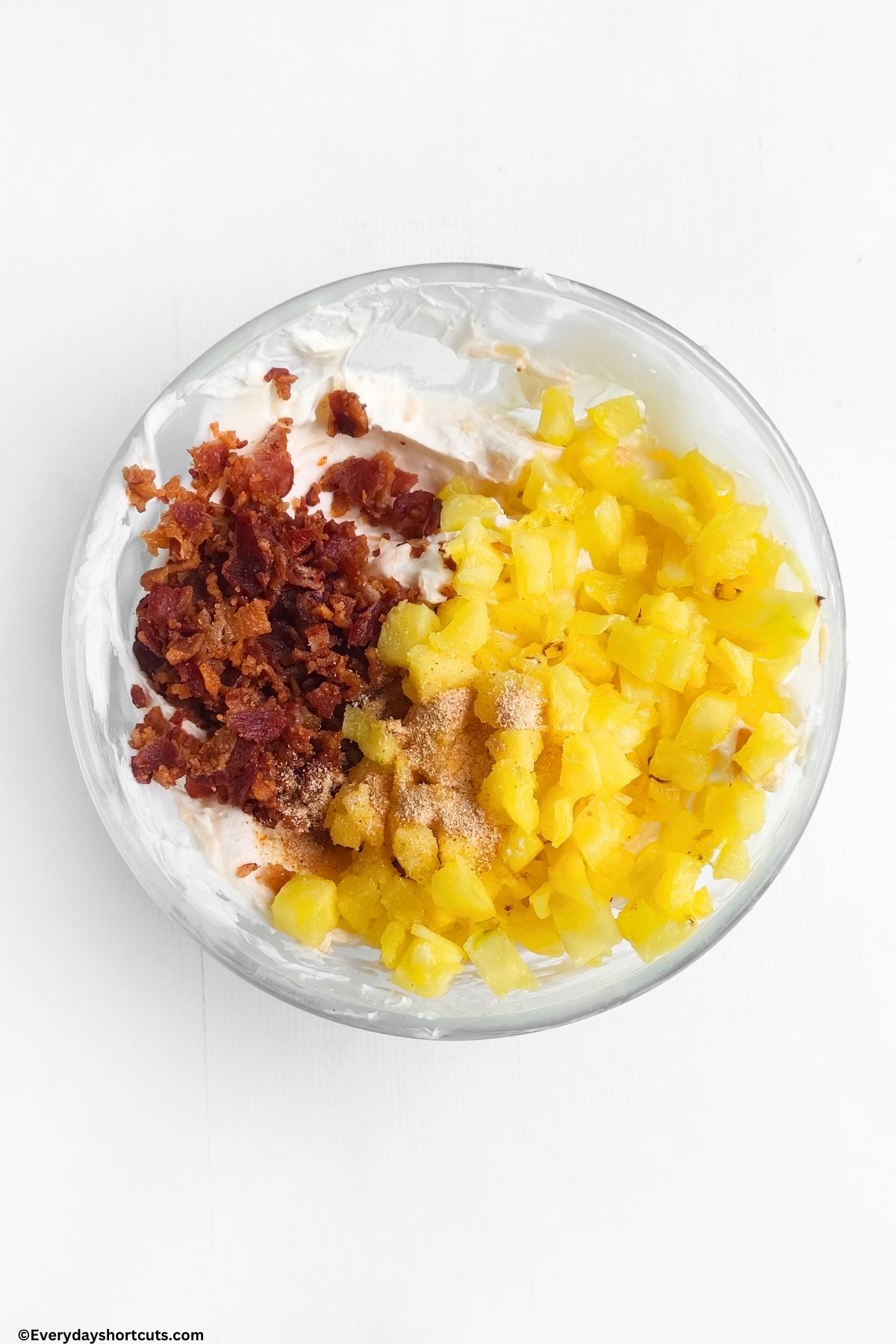 cream cheese bacon pineapple and garlic powder in a bowl