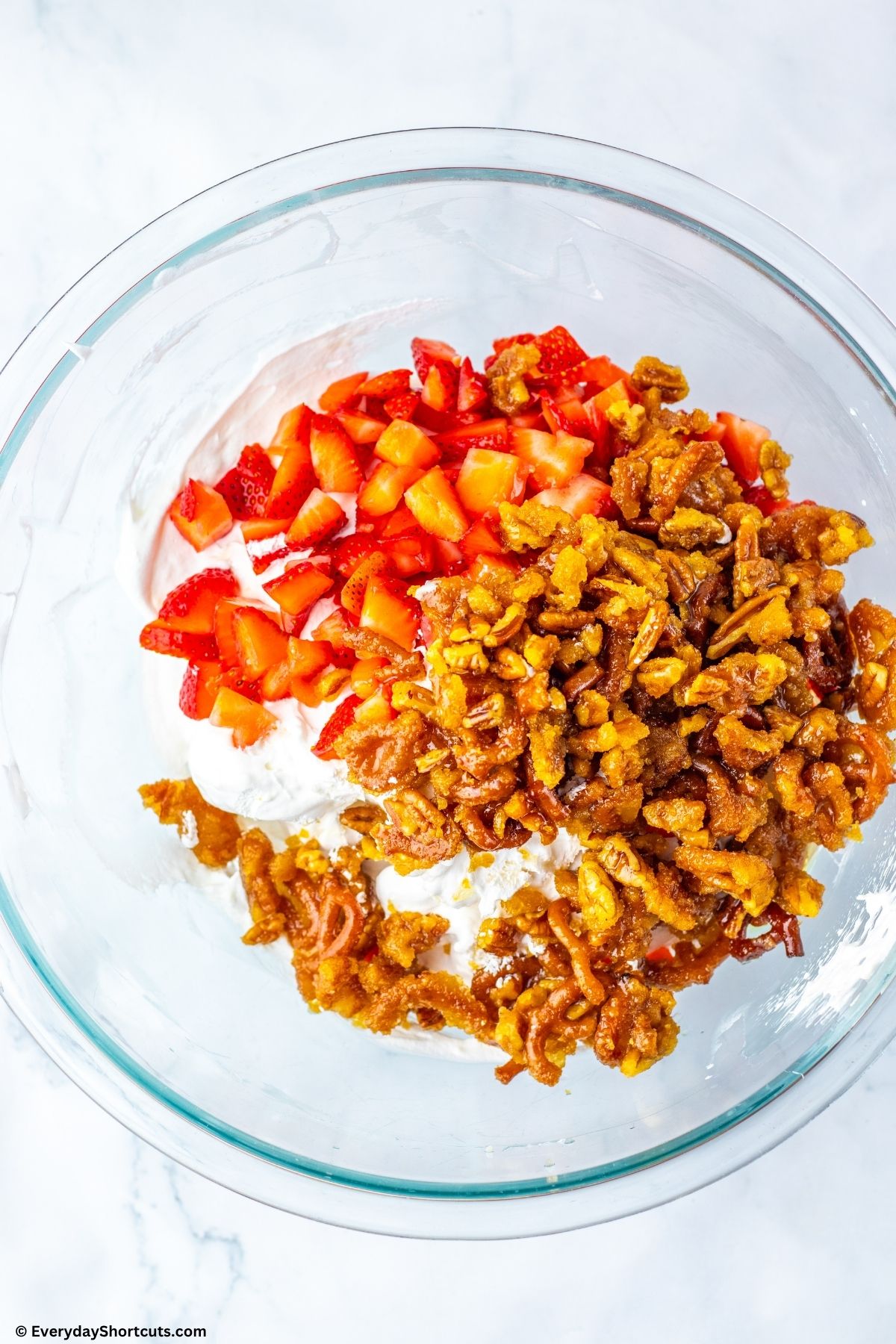 pecans strawberries and creamy fluff mixture in a bowl