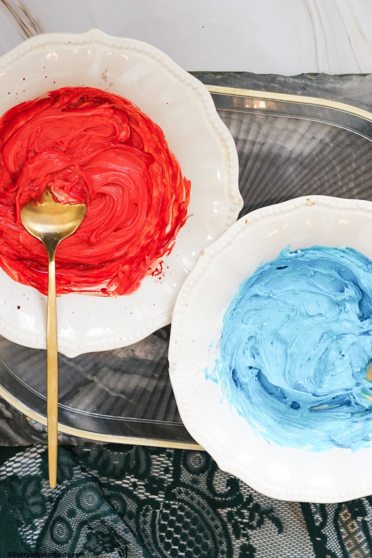 red and blue frosting in bowls