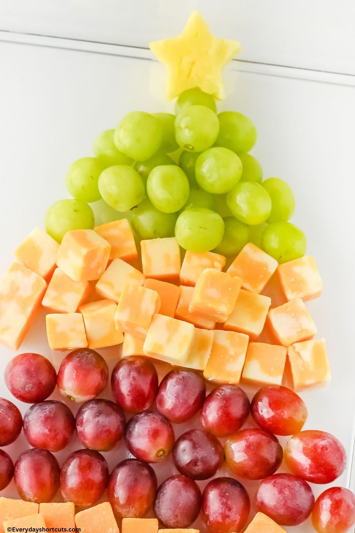 pineapple in the shaped of a star on a platter with other fruits