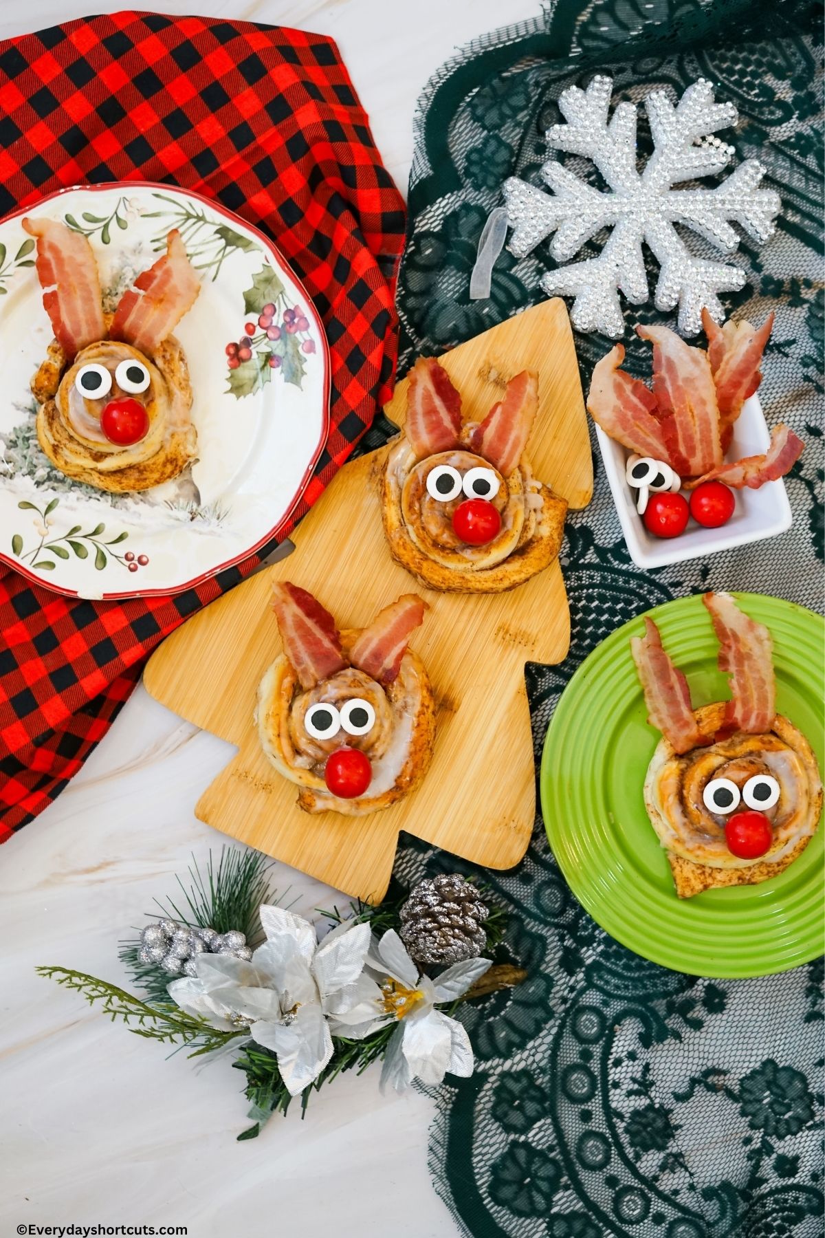 rudolph cinnamon rolls on plates and tree board