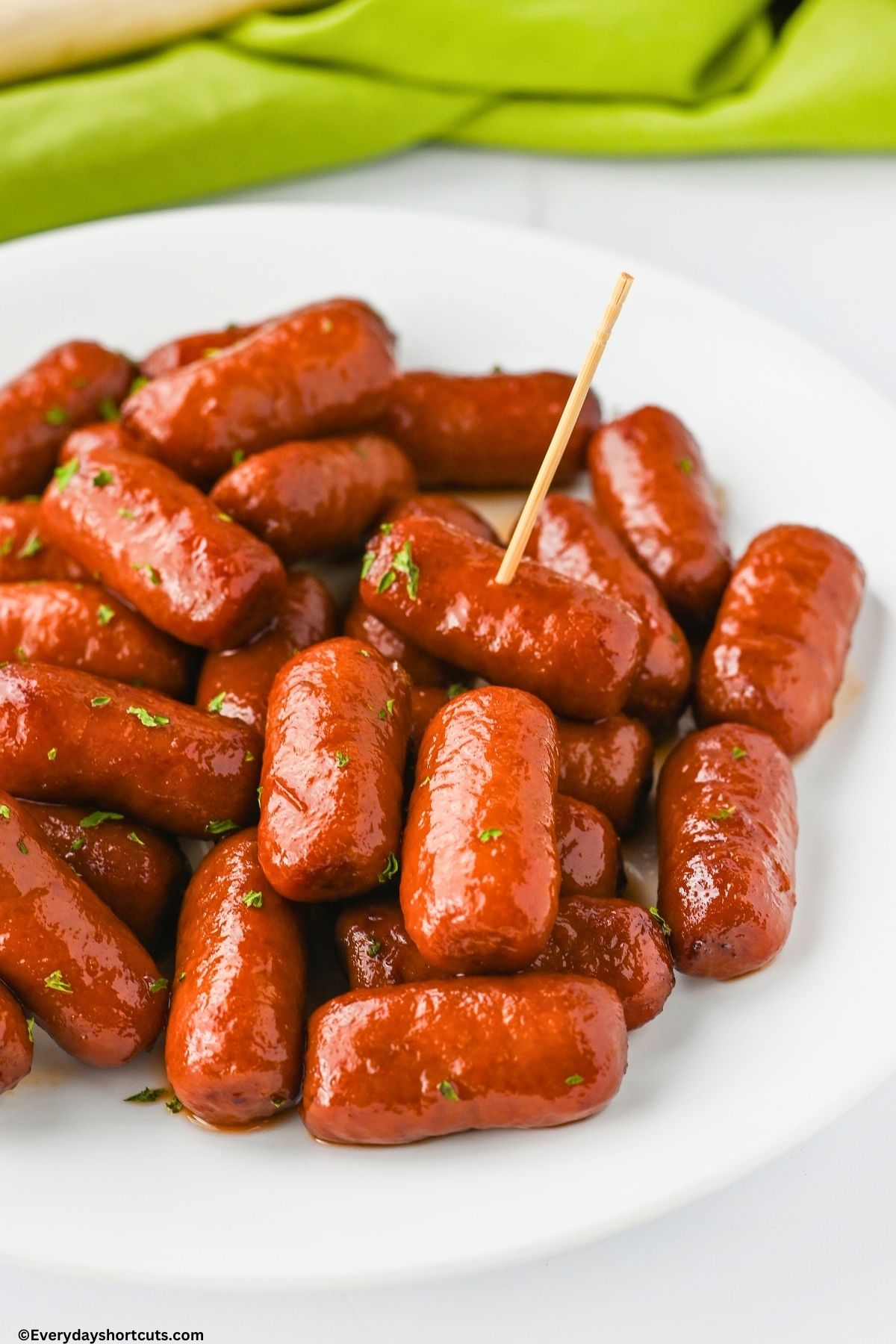 Little smokies on a plate with a toothpick in one