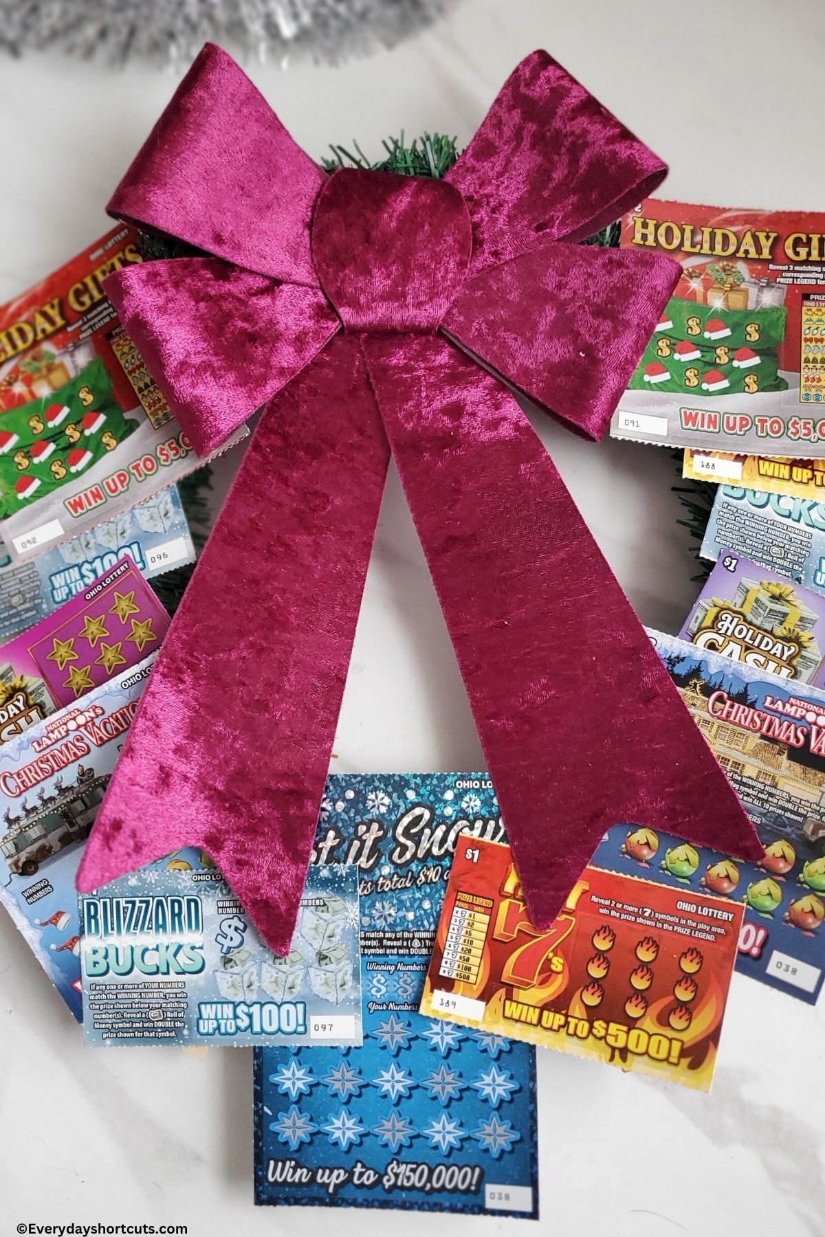 scratch offs arranged in a circle on a wreath and a bow on top