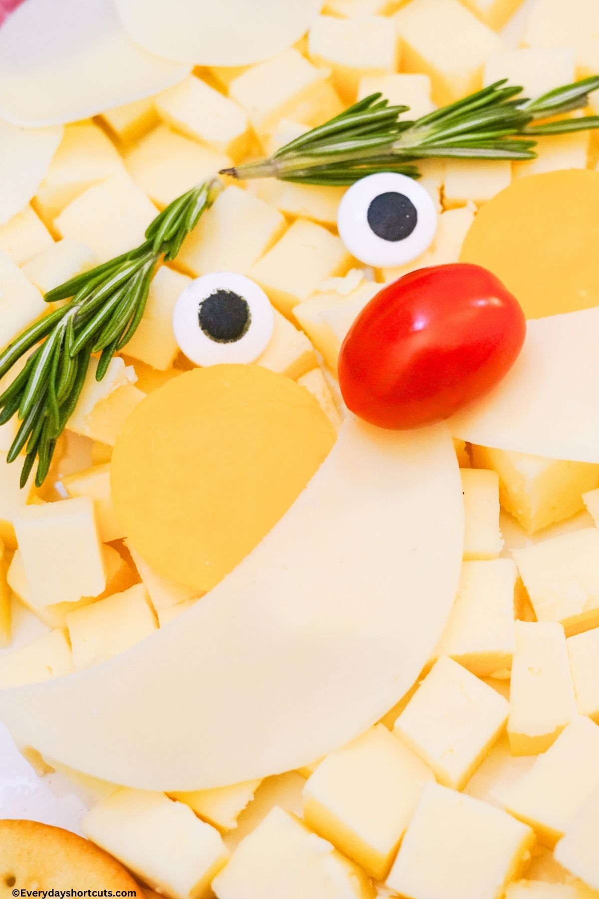 rosemary sprigs for eyebrows and mozzarella cheese slices for mustache on Santa face