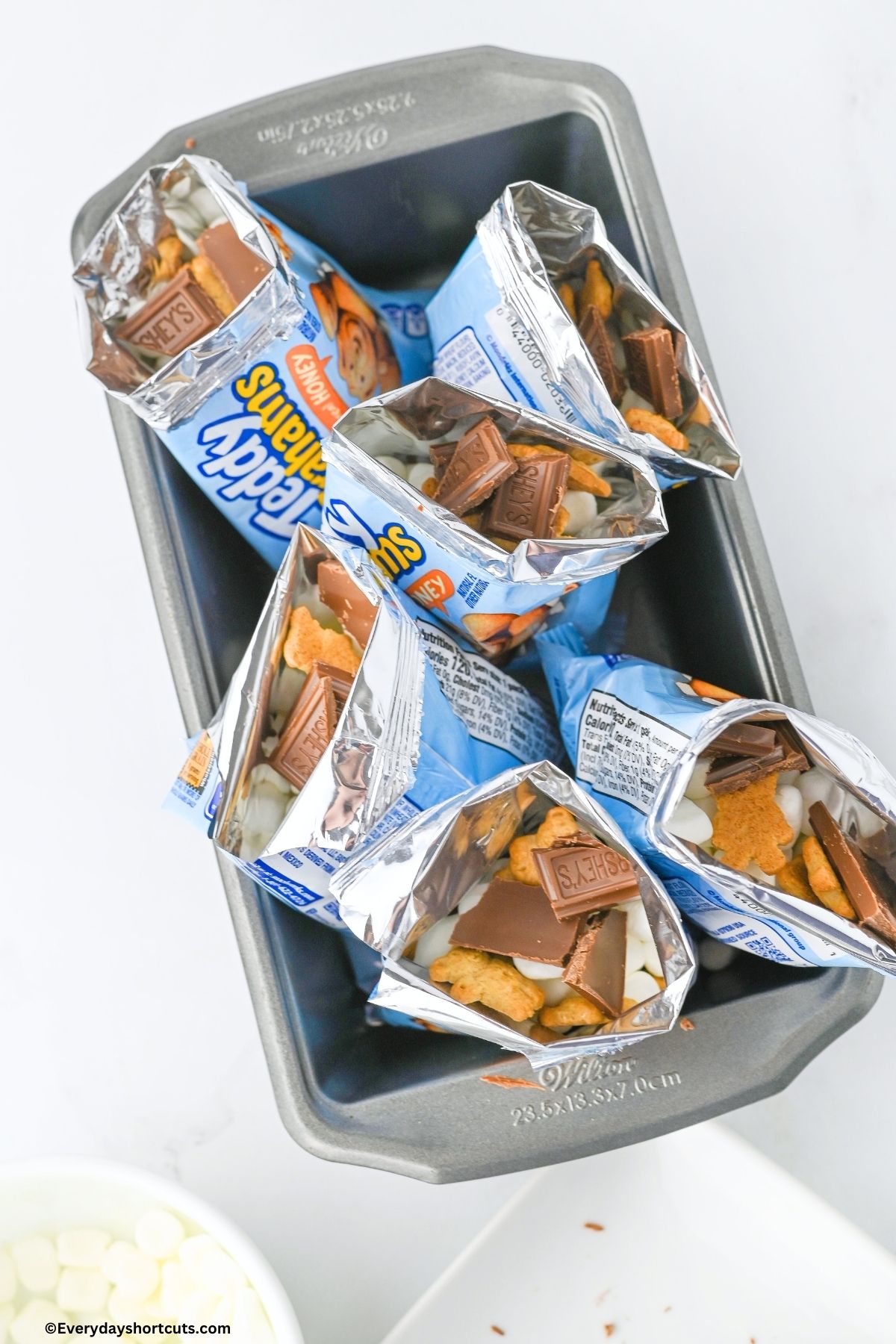 Teddy Grahams bags filled with mini marshmallows and Hershey chocolate pieces in a loaf pan