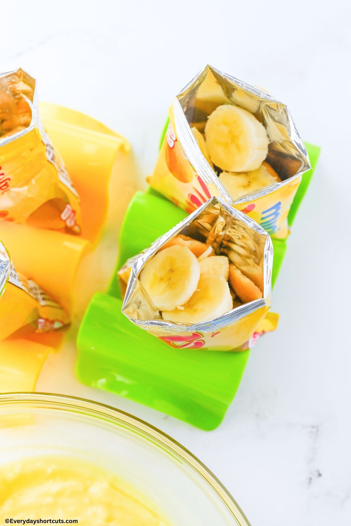 banana slices on top of Nilla wafers packs on a green taco stand