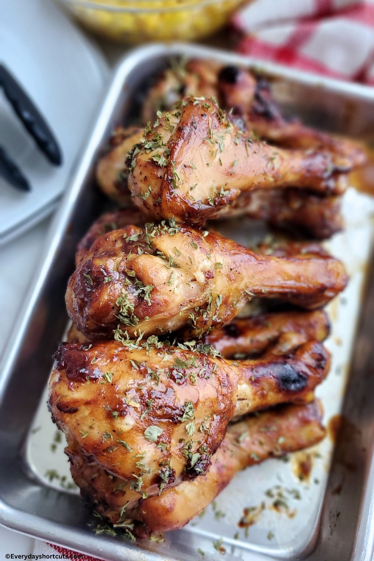 Baked BBQ chicken drumsticks on a sheet pan