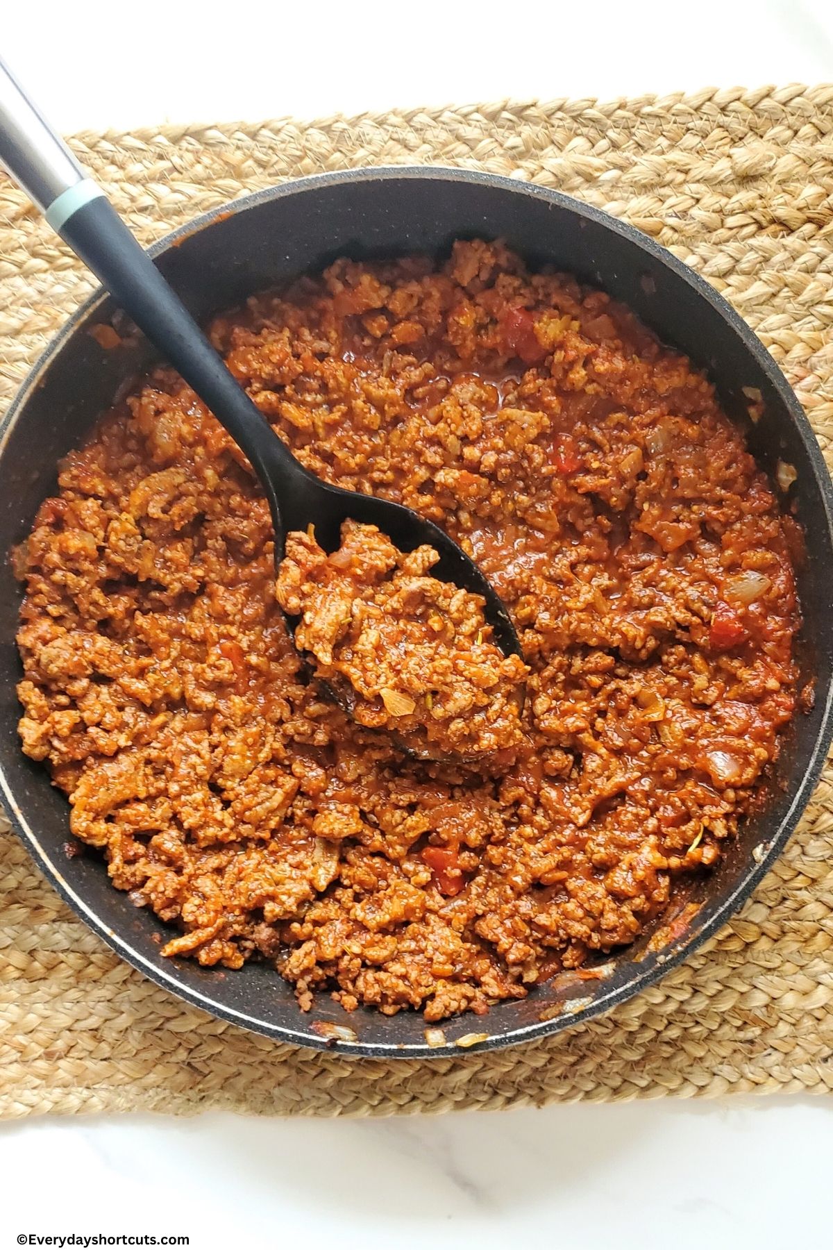 ground beef, Italian sausage, onions, garlic and marinara sauce cooked in a pan