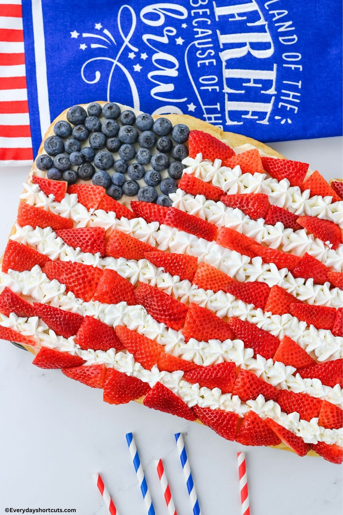 blueberries strawberries and cool whip as stars and stripes on a sugar cookie base