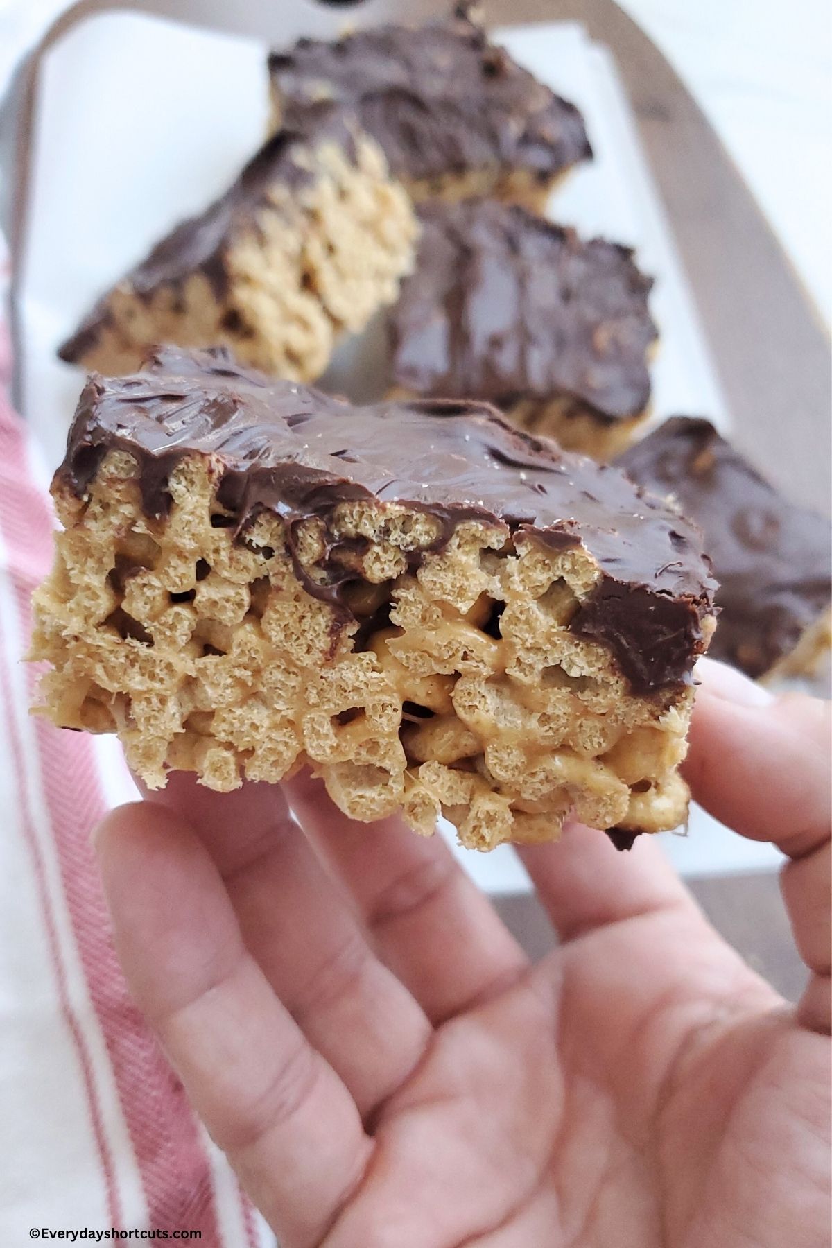 holding a peanut butter Cheerios bar