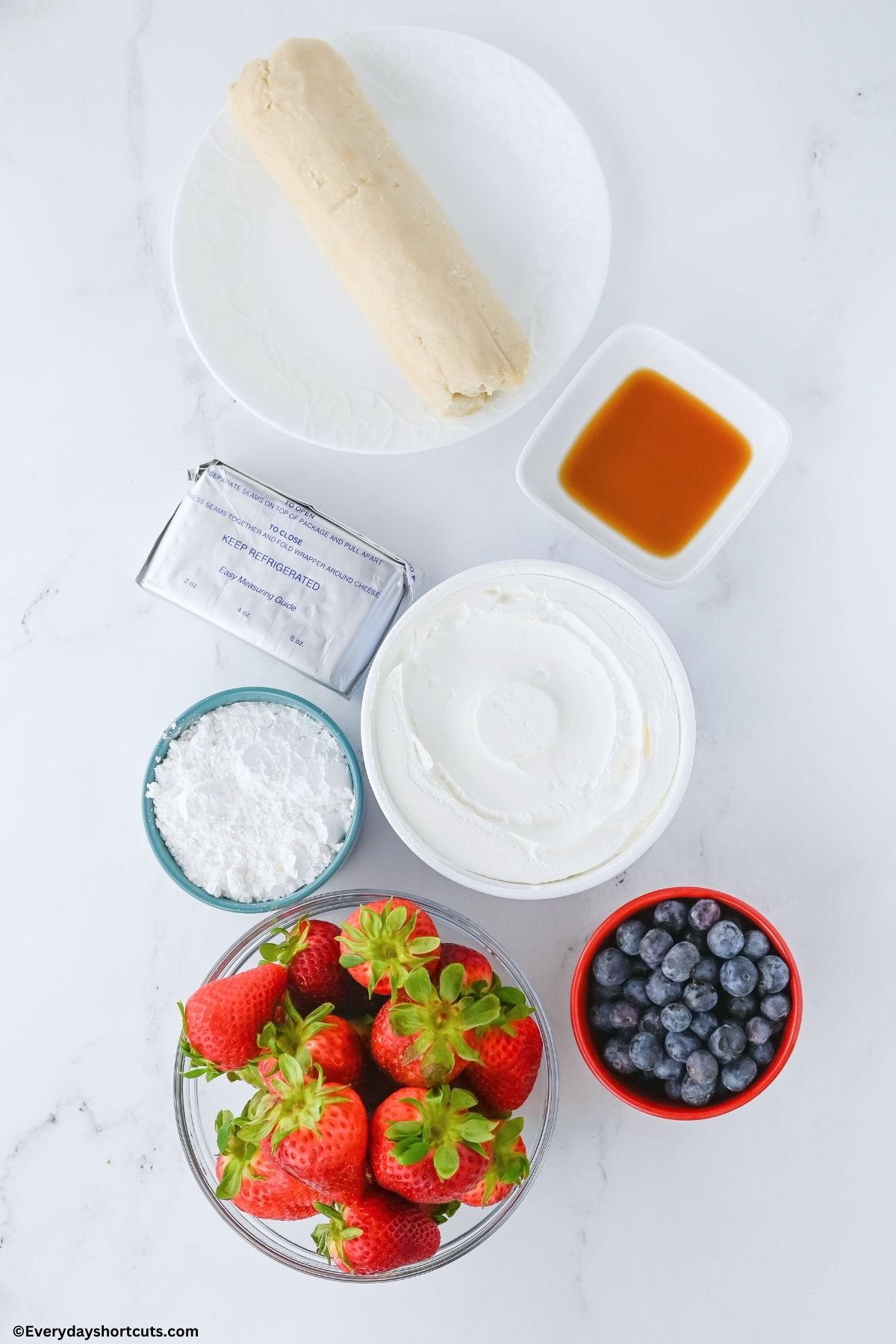sugar cookie dough roll vanilla extract cream cheese cool whip powdered sugar strawberries and blueberries on a white board