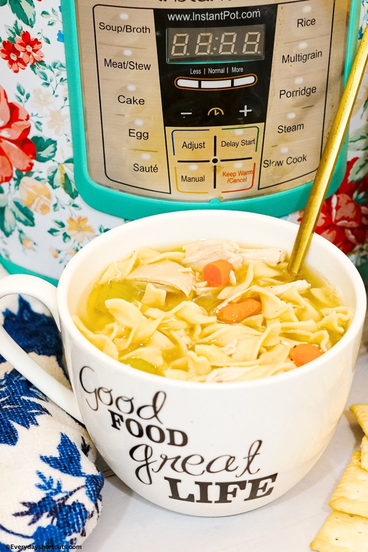 Instant pot rotisserie chicken noodle soup in a cup with a spoon