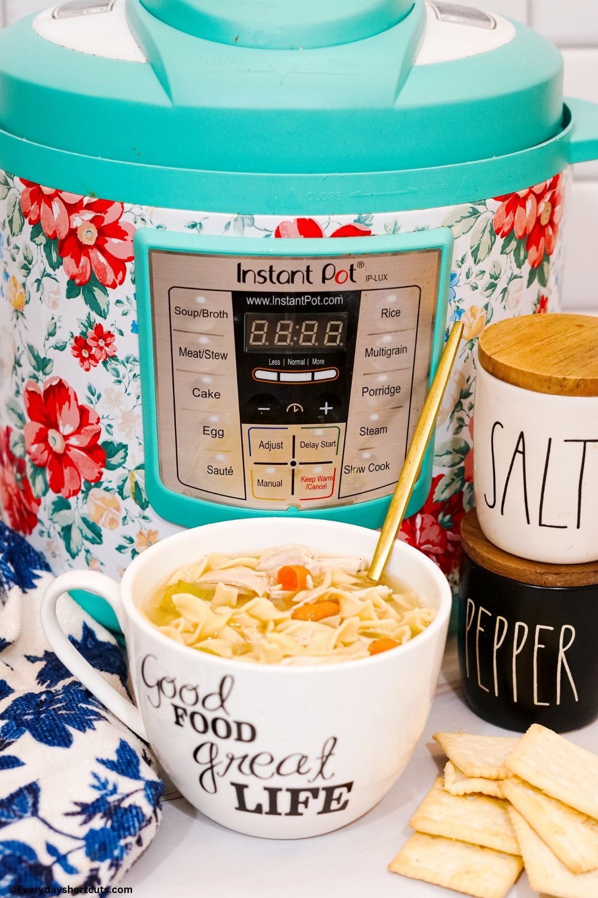instant pot next to a bowl of chicken noodle soup with shredded chicken in a bowl