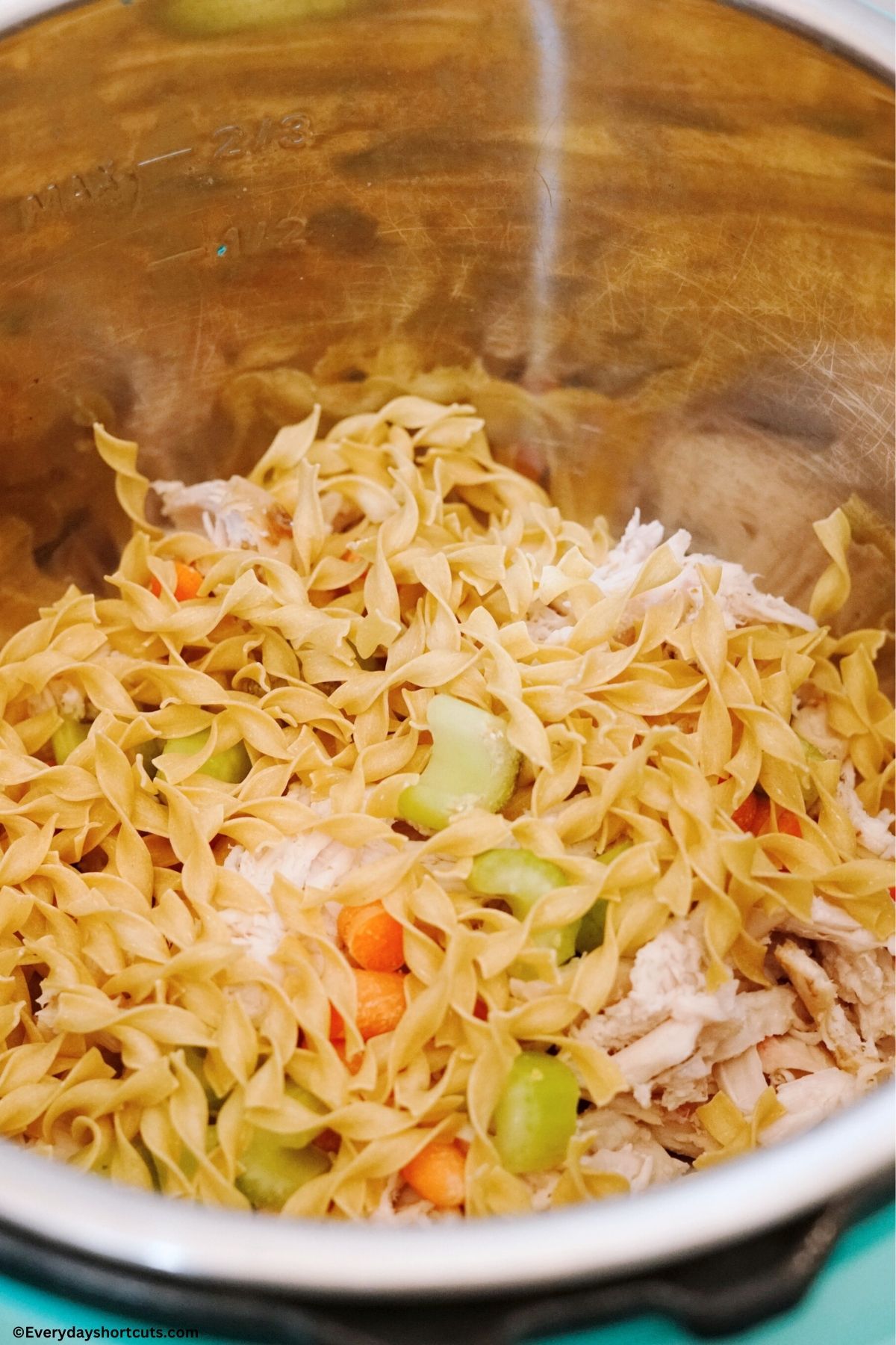 egg noodles carrots celery and shredded chicken in an instant pot