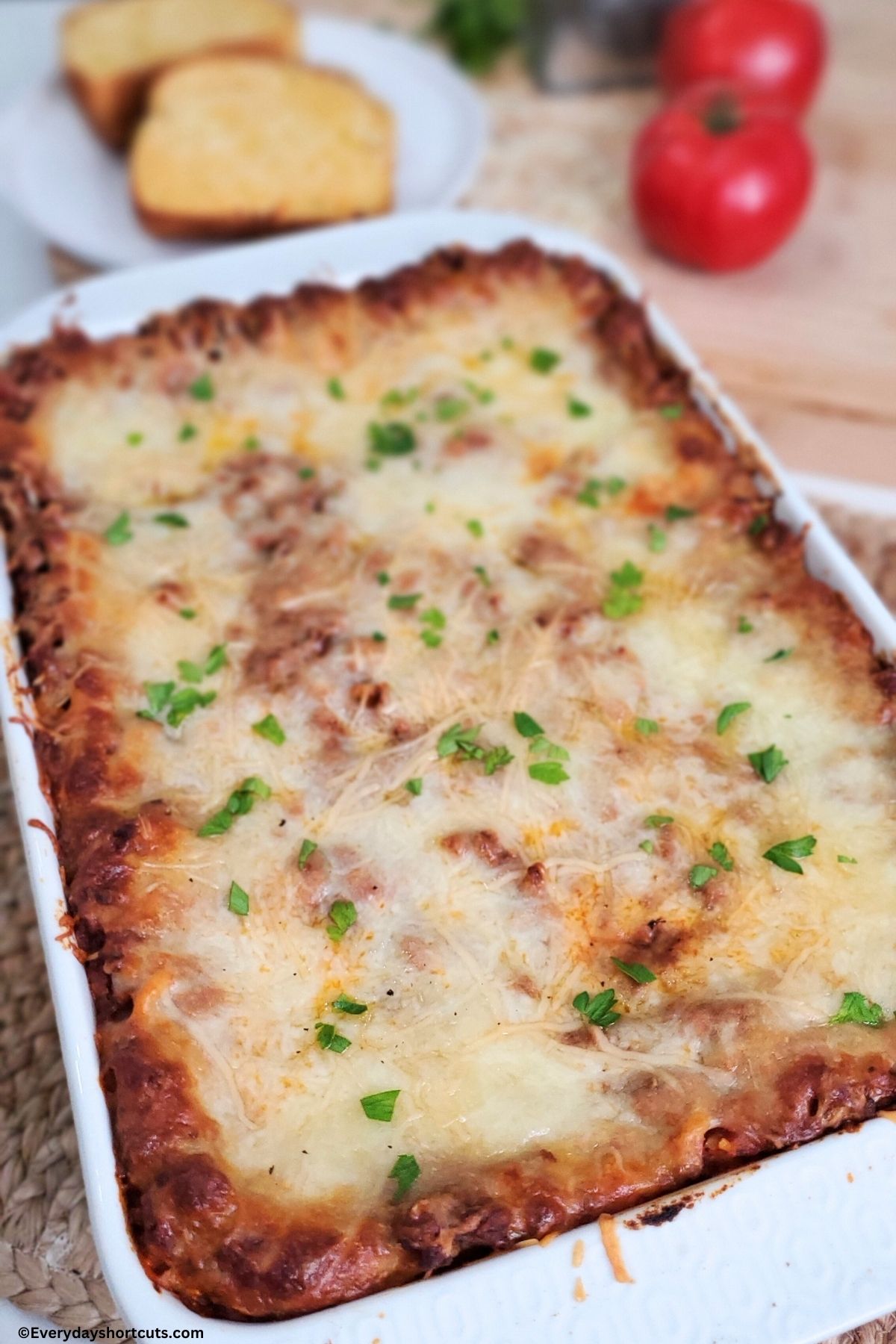 baked million dollar spaghetti in a white casserole dish