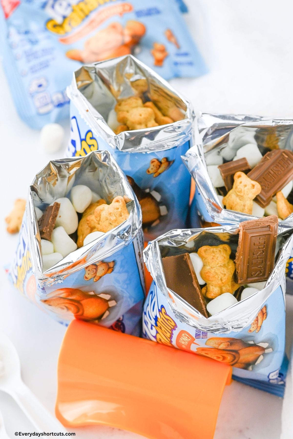 Walking s'mores bags being held upright on an orange taco stand