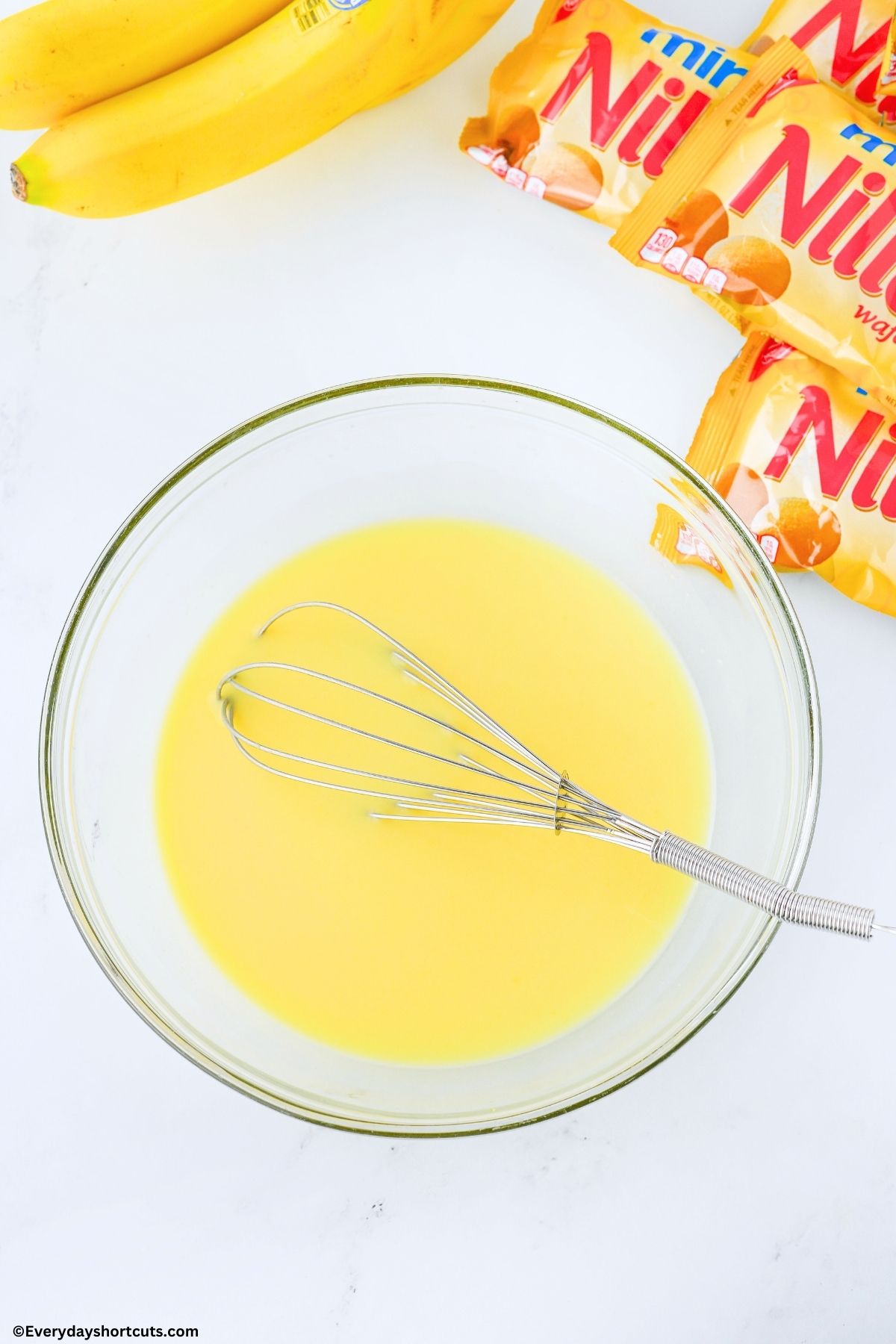 vanilla pudding mix in a bowl with a whisk